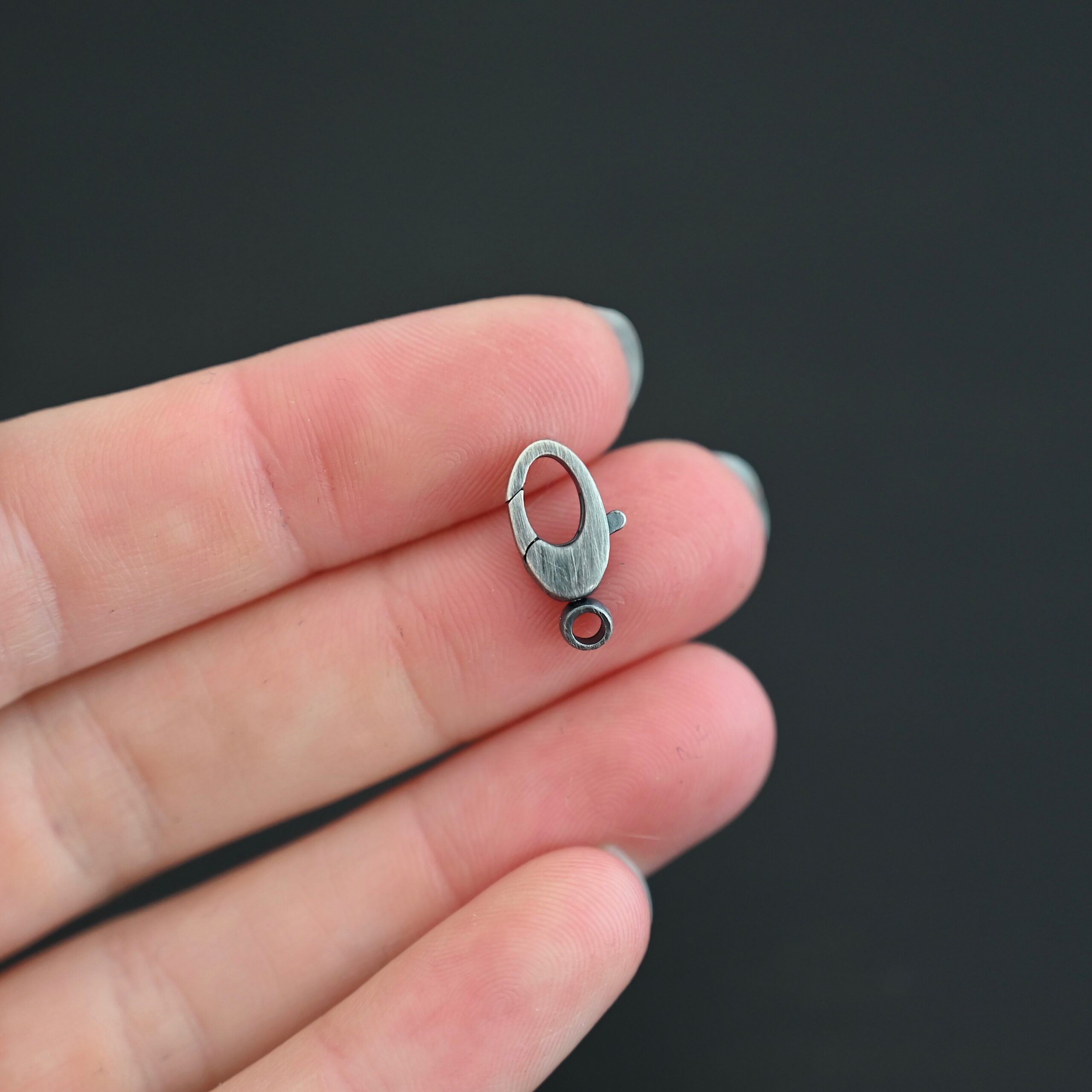 Sunny Swivel Lobster Claw clasp - oxidized Sunny Swivel Lobster Claw clasp - oxidized shown in hand