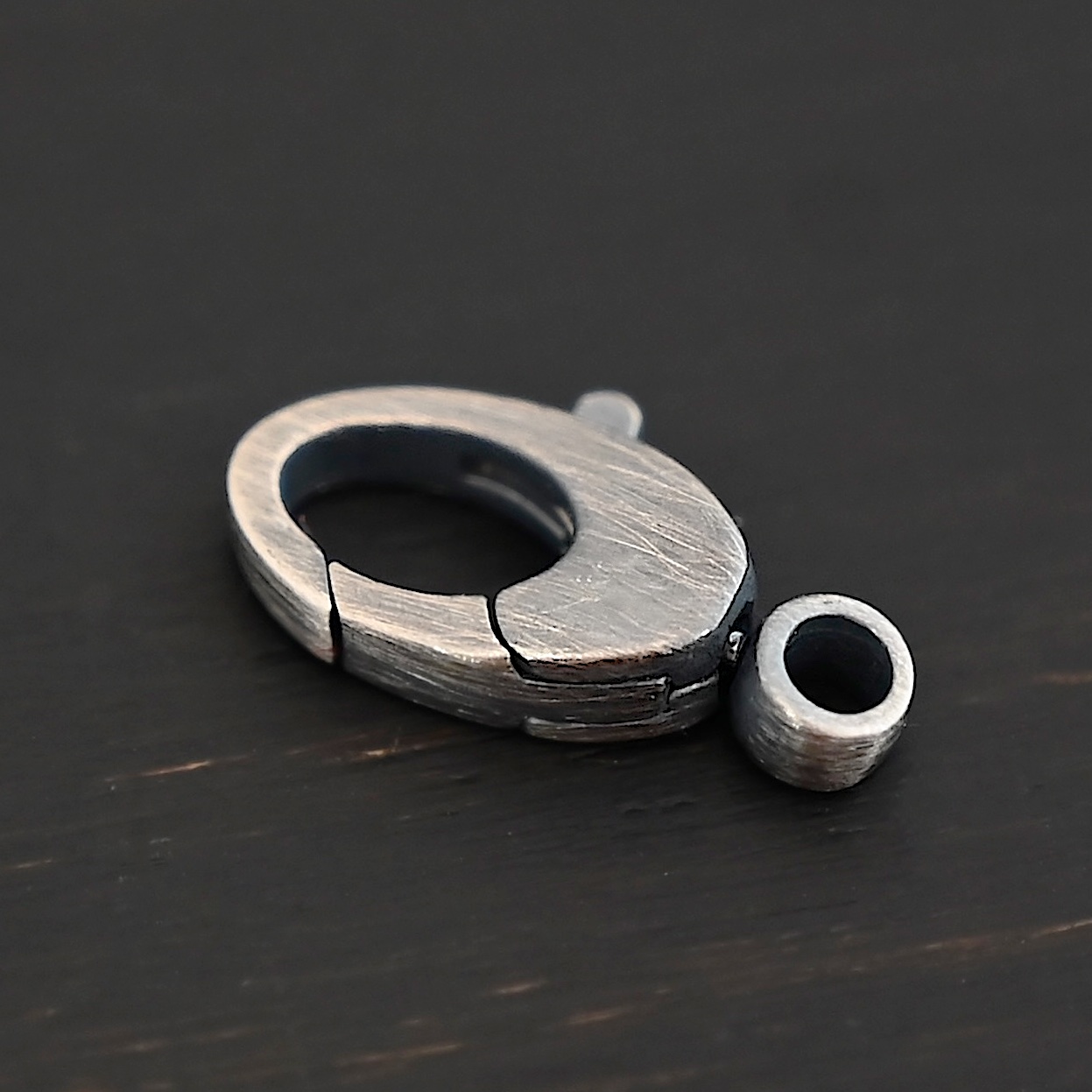 Sunny Swivel Lobster Claw clasp - oxidized Sunny Swivel Lobster Claw clasp - oxidized shown on dark background