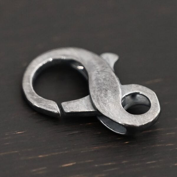 Faith Figure 8 Lobster Claw - oxidized shown on dark background