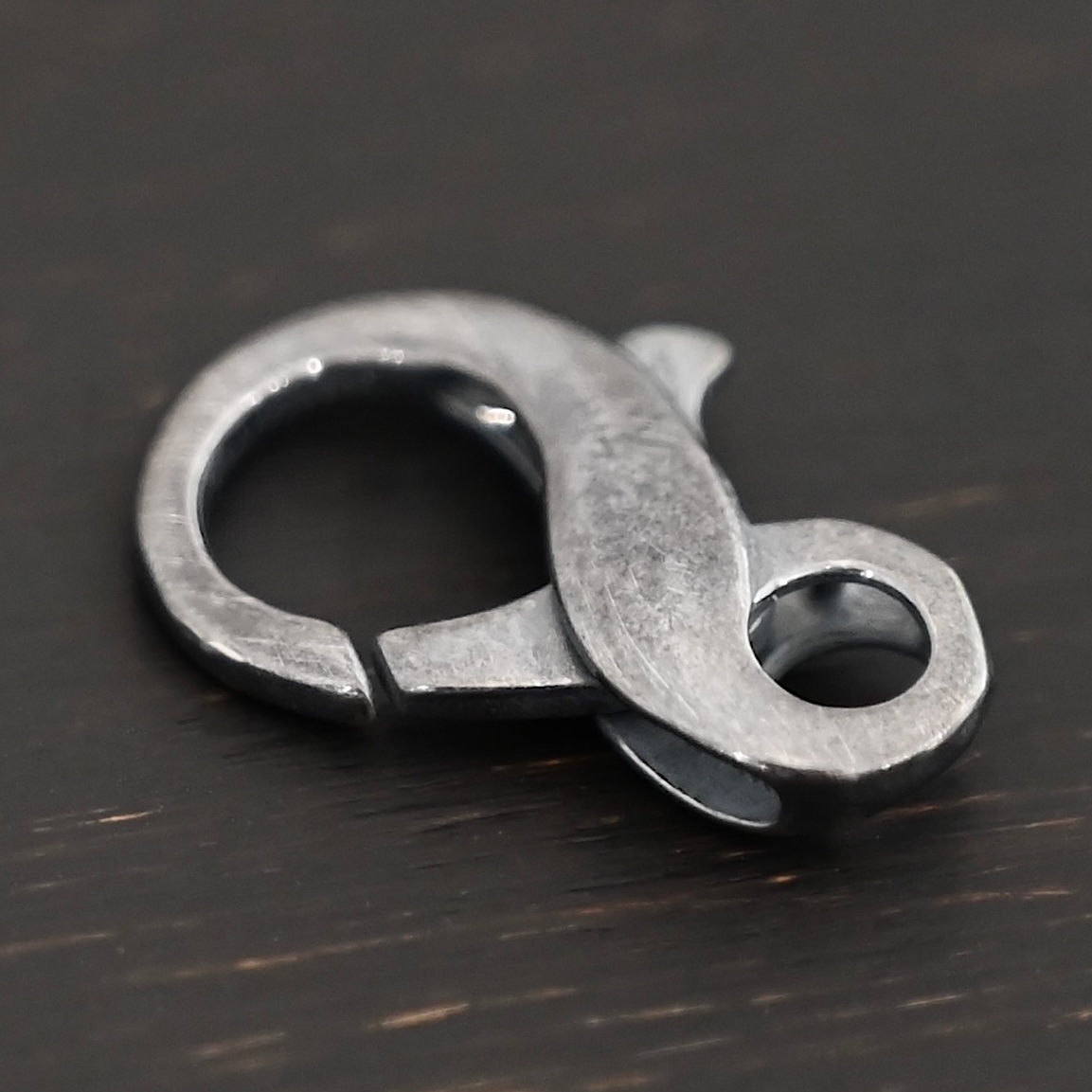 Faith Figure 8 Lobster Claw - oxidized Faith Figure 8 Lobster Claw - oxidized shown on dark background