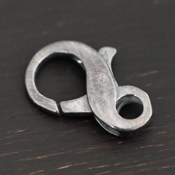 Faith Figure 8 Lobster Claw - oxidized shown on dark background
