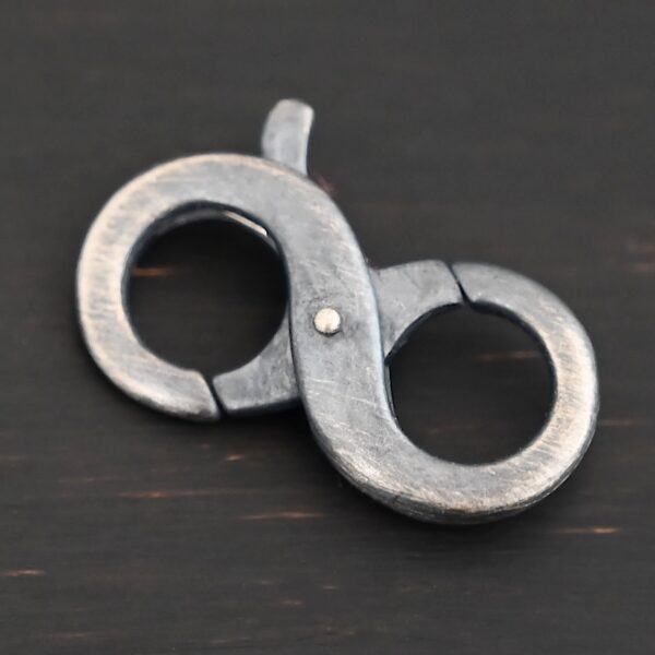 Daisy double lobster claw - oxidized shown on dark background