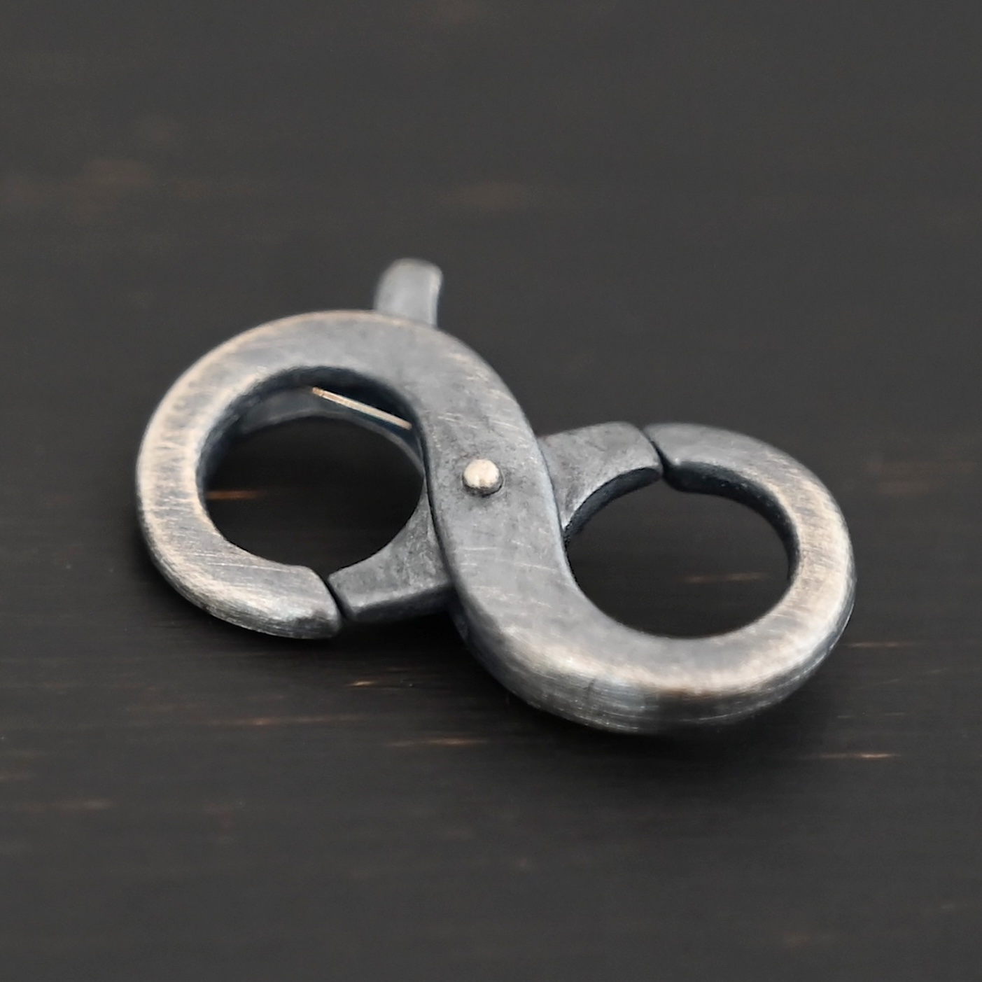 Daisy double lobster claw - oxidized shown on dark background