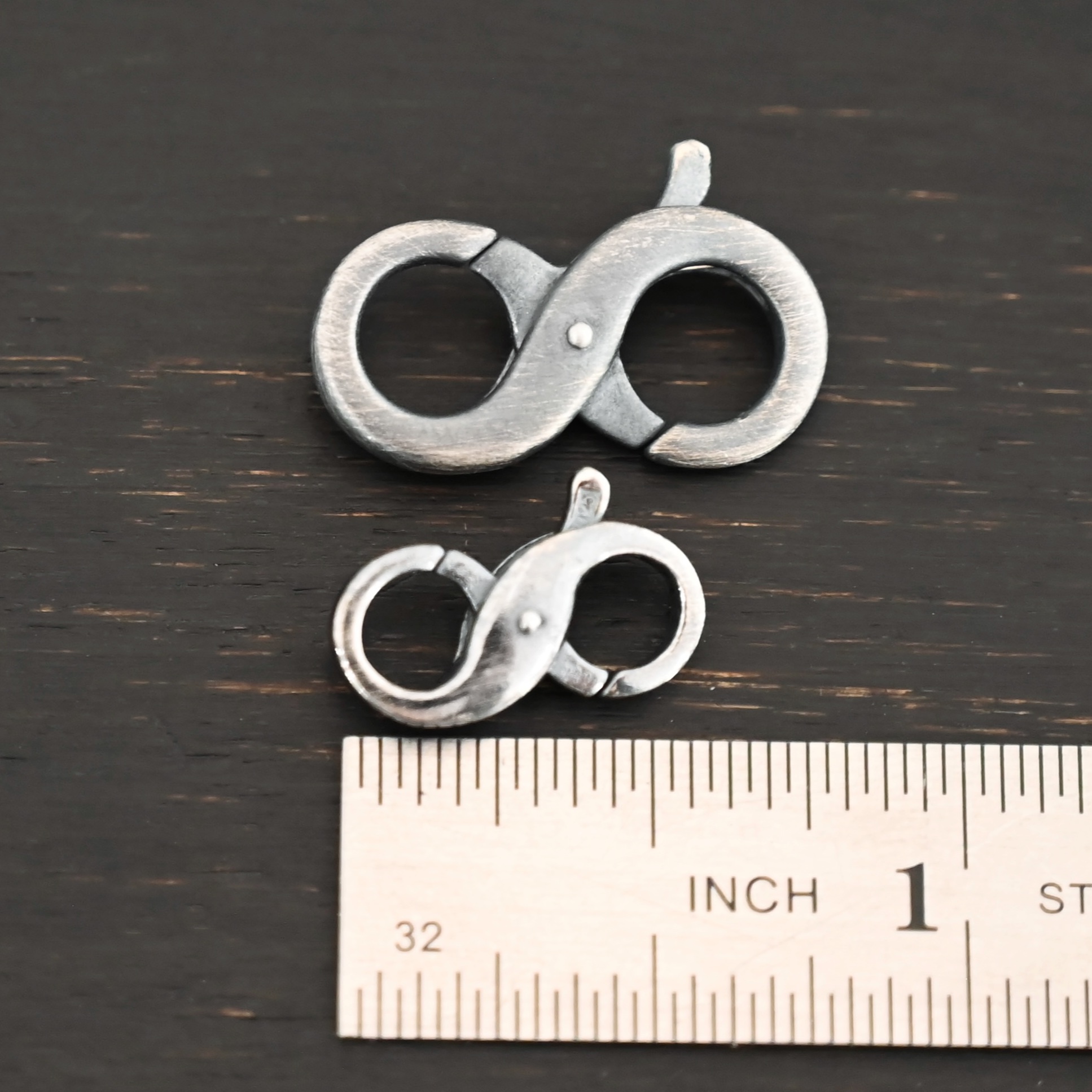 Daisy double lobster claw - oxidized shown by ruler