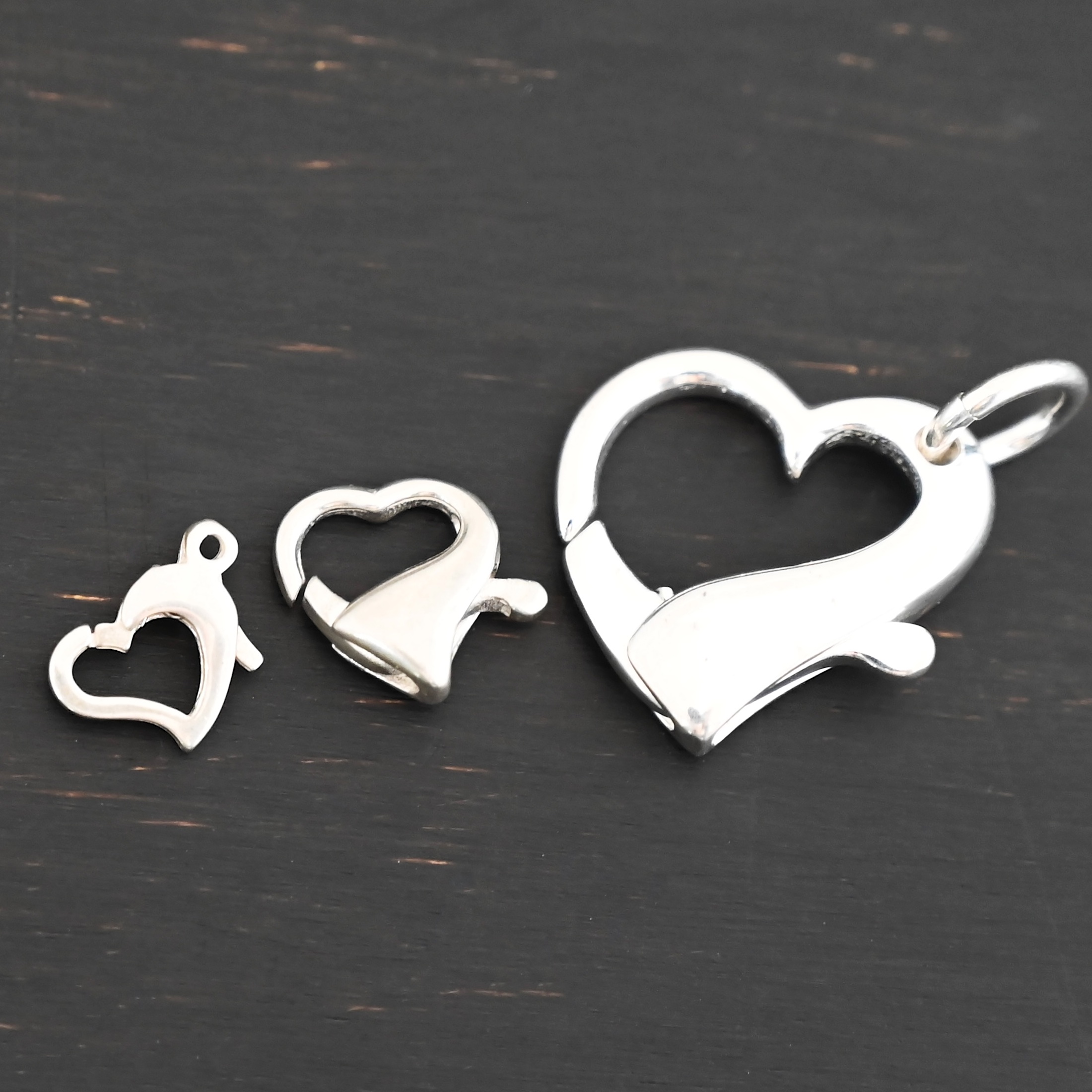 Hallie Heart Lobster Claw - shiny shown on dark background