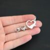 Hallie Heart Lobster Claw - shiny shown in hand