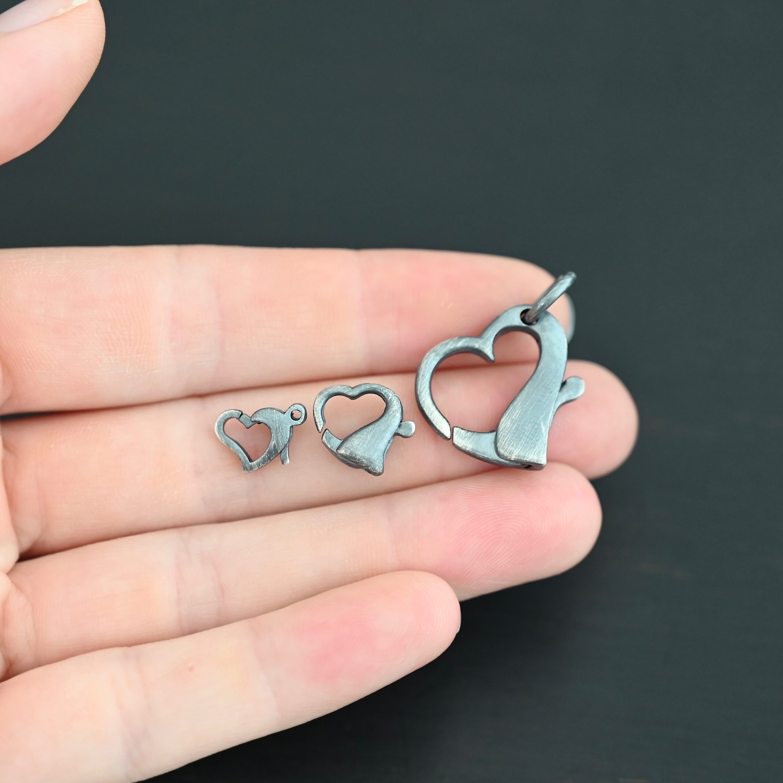 Hallie Heart Lobster Claw - oxidized shown in hand