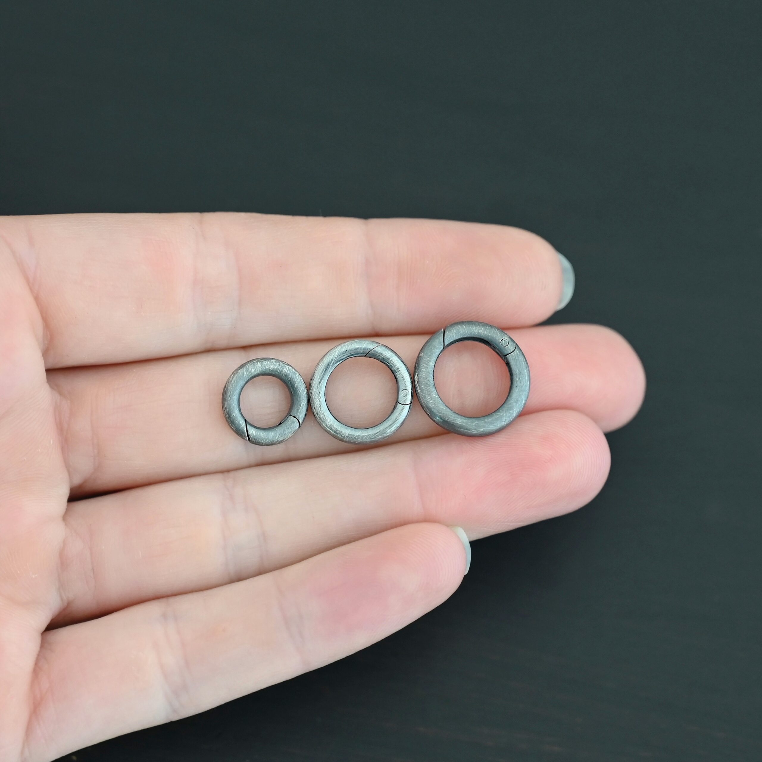 Piper Push Clasp - oxidized shown in hand