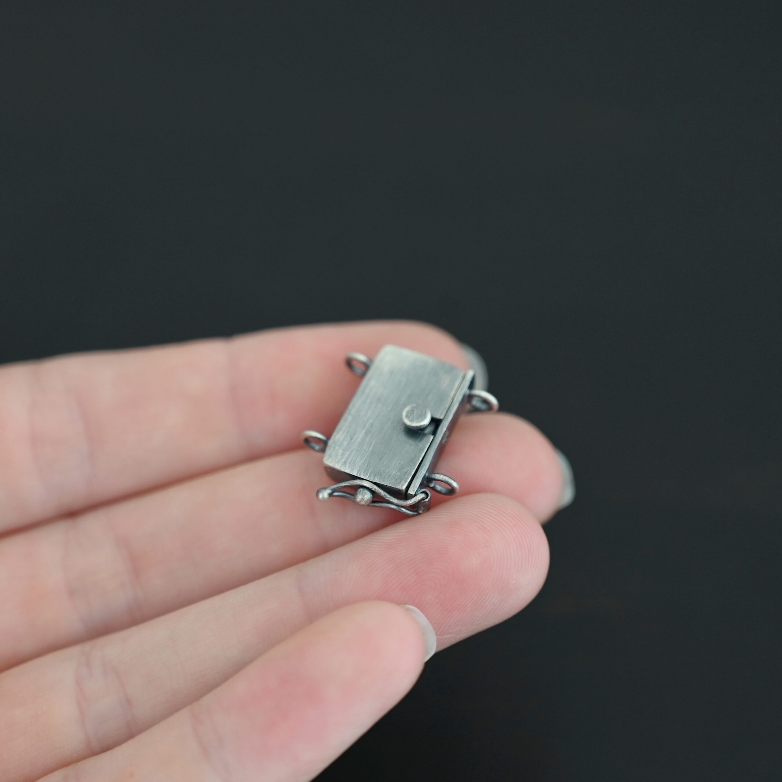 Box Clasp - oxidized shown in hand