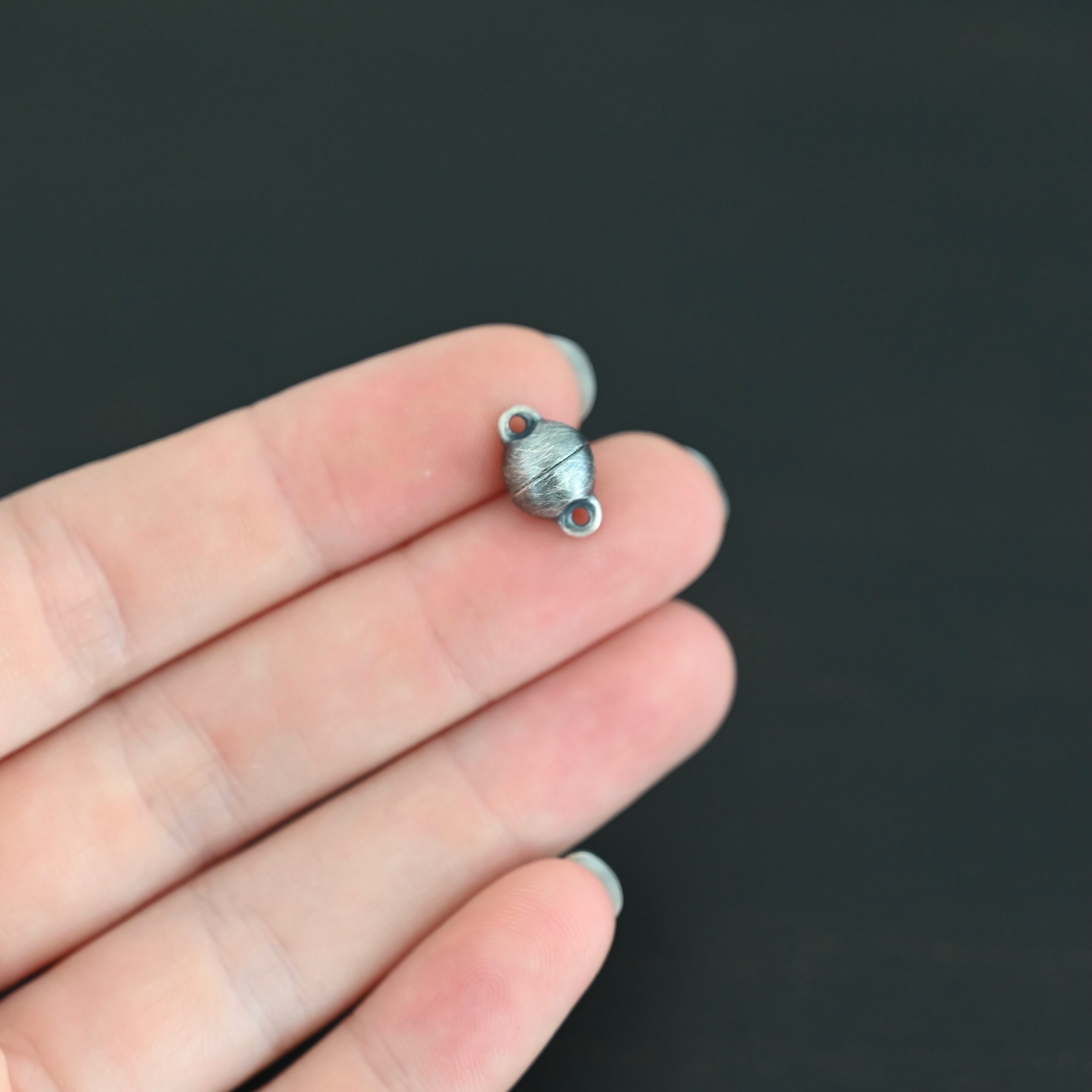 Melody Round Magnetic Clasp - oxidized shown in hand