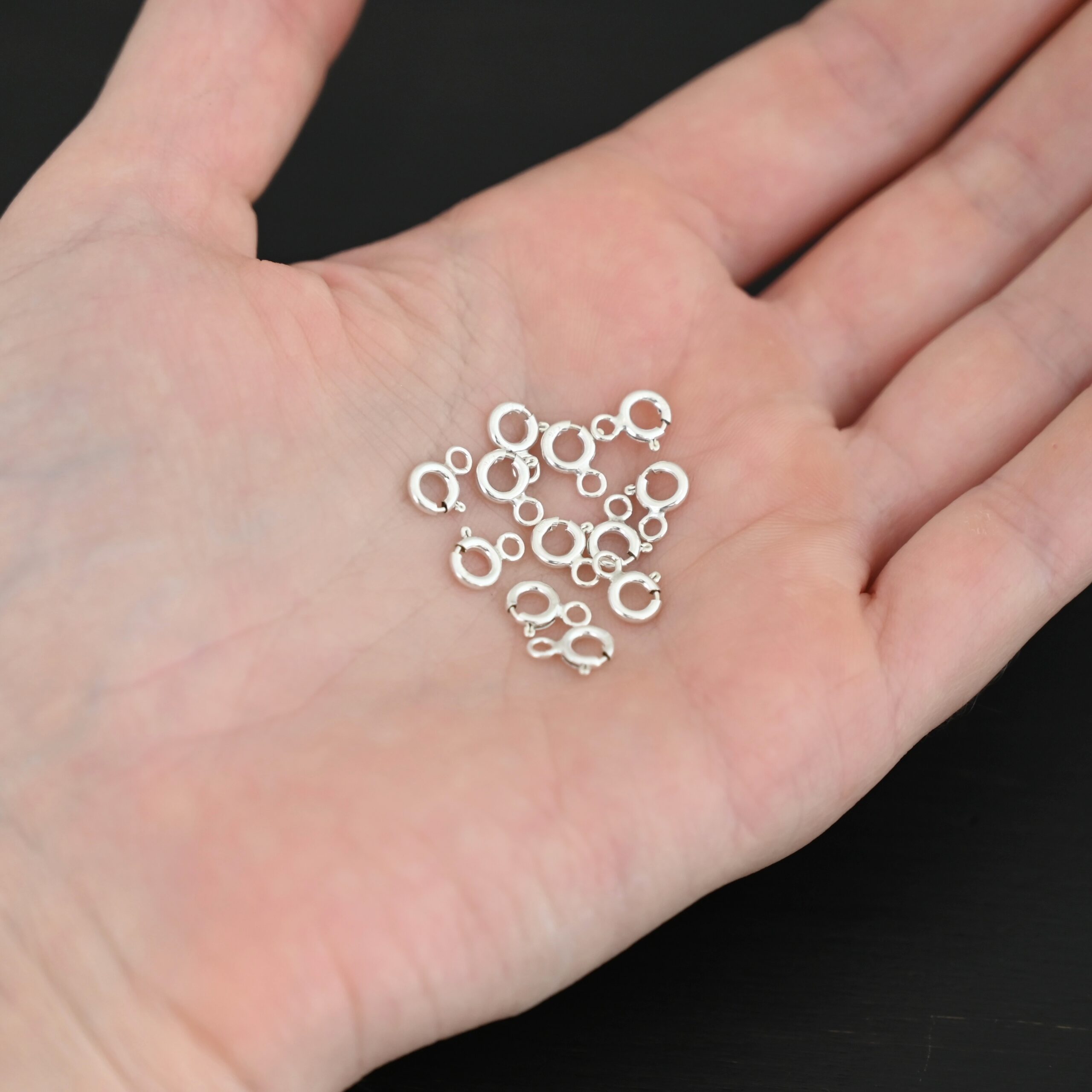 Sky Spring Ring Clasps - 12pcs shiny shown in hand