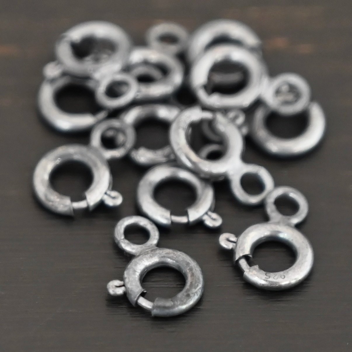 Sky Spring Ring Clasps - oxidized shown on dark background