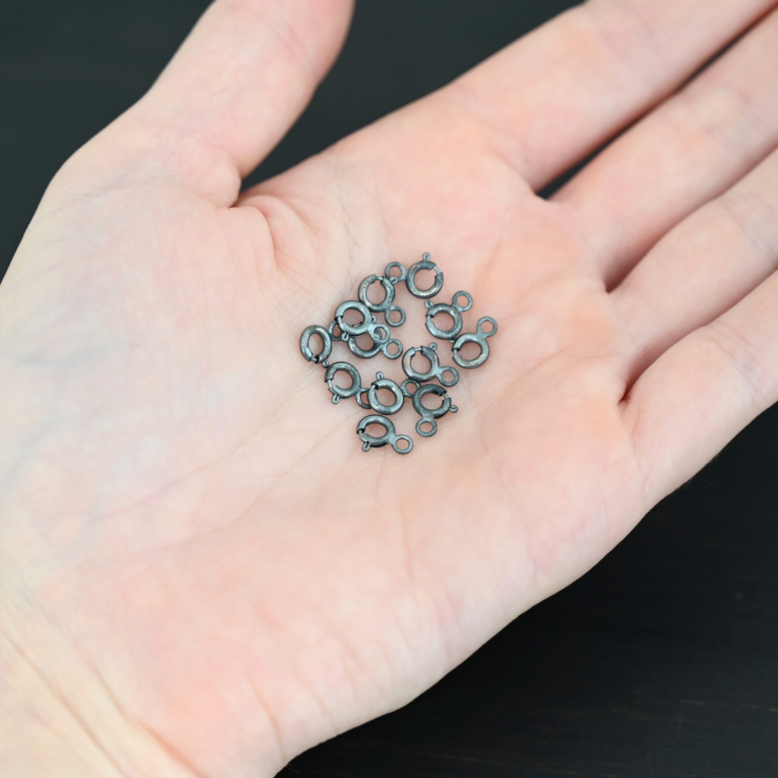 Sky Spring Ring Clasps - 12pcs oxidized shown in hand