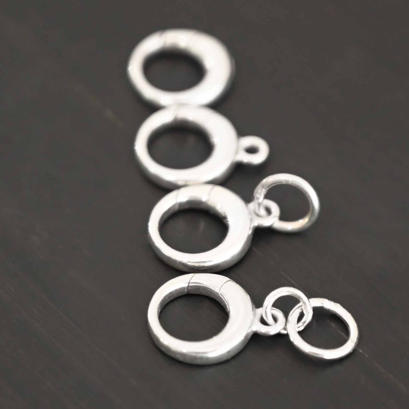 Pearl Push Clasp - small shiny shown on dark background