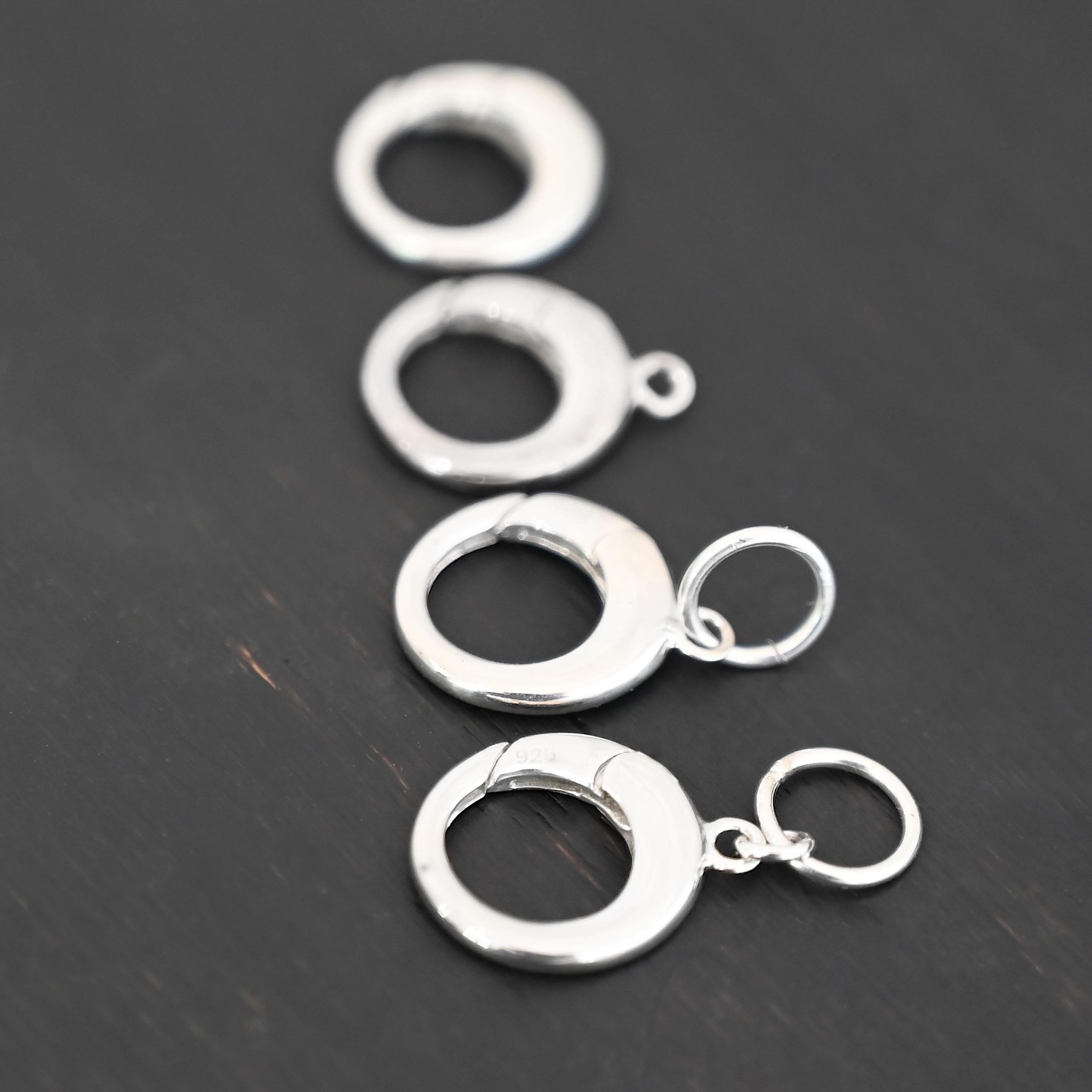 Pearl Push Clasp - large shiny shown on dark background