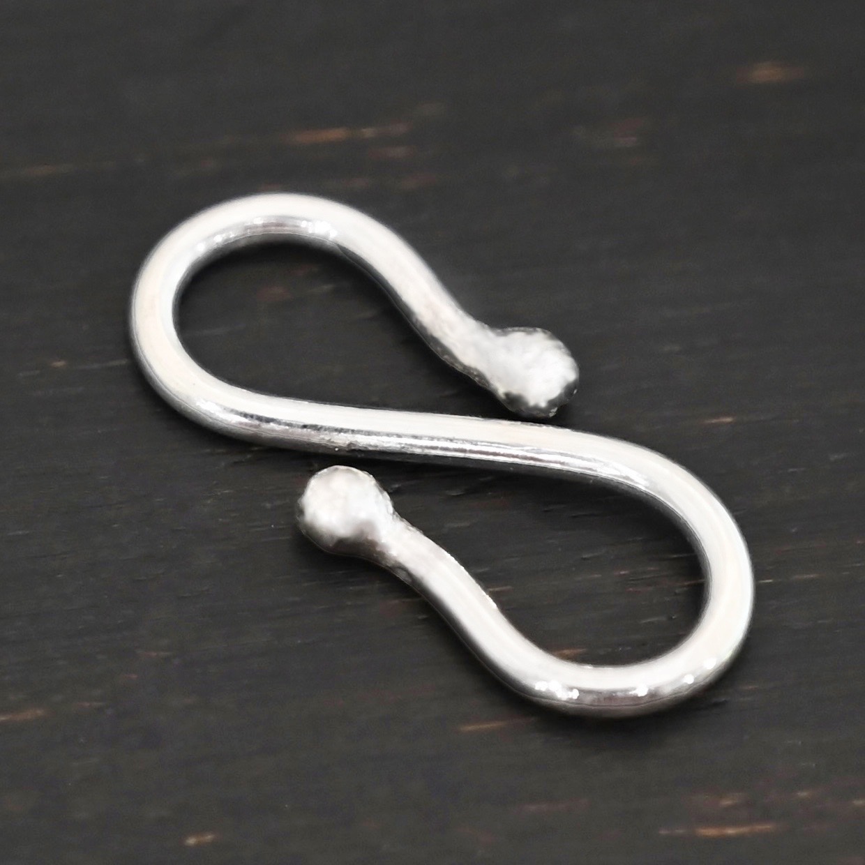 Saint S Clasp - shiny shown on dark background