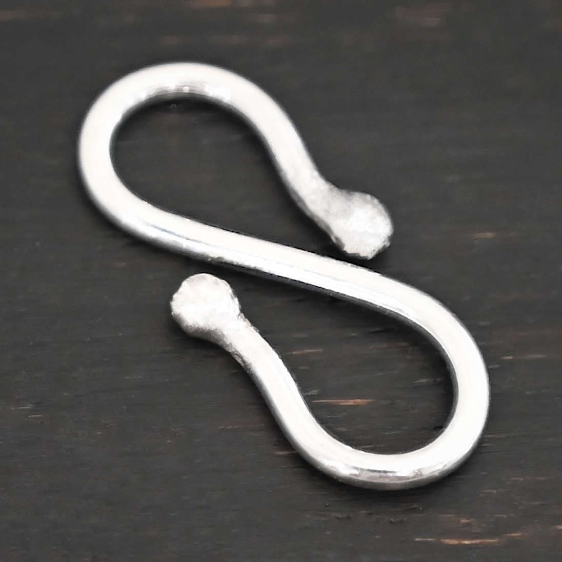 Saint S Clasp - shiny shown on dark background