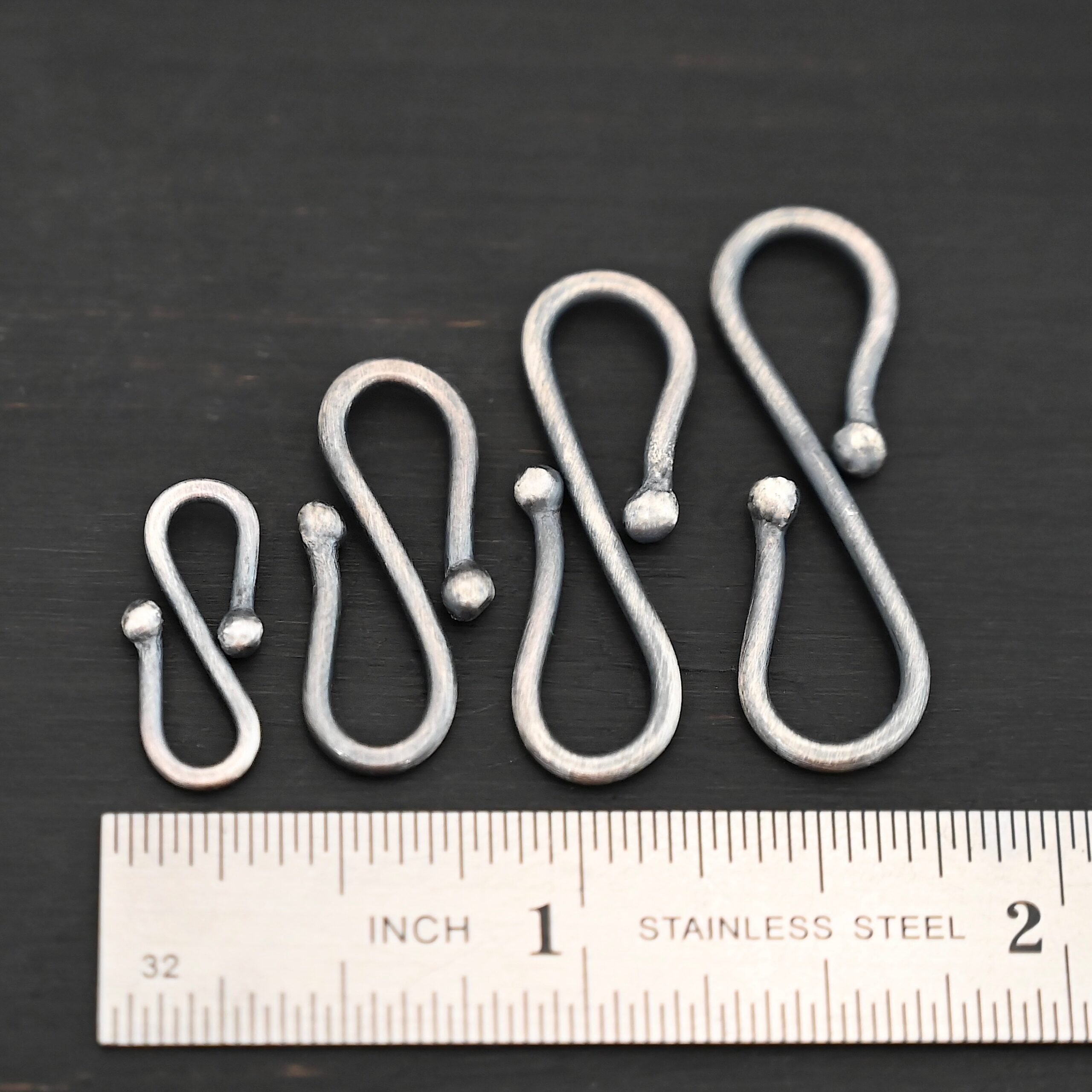 Saint S Clasp - oxidized shown by ruler