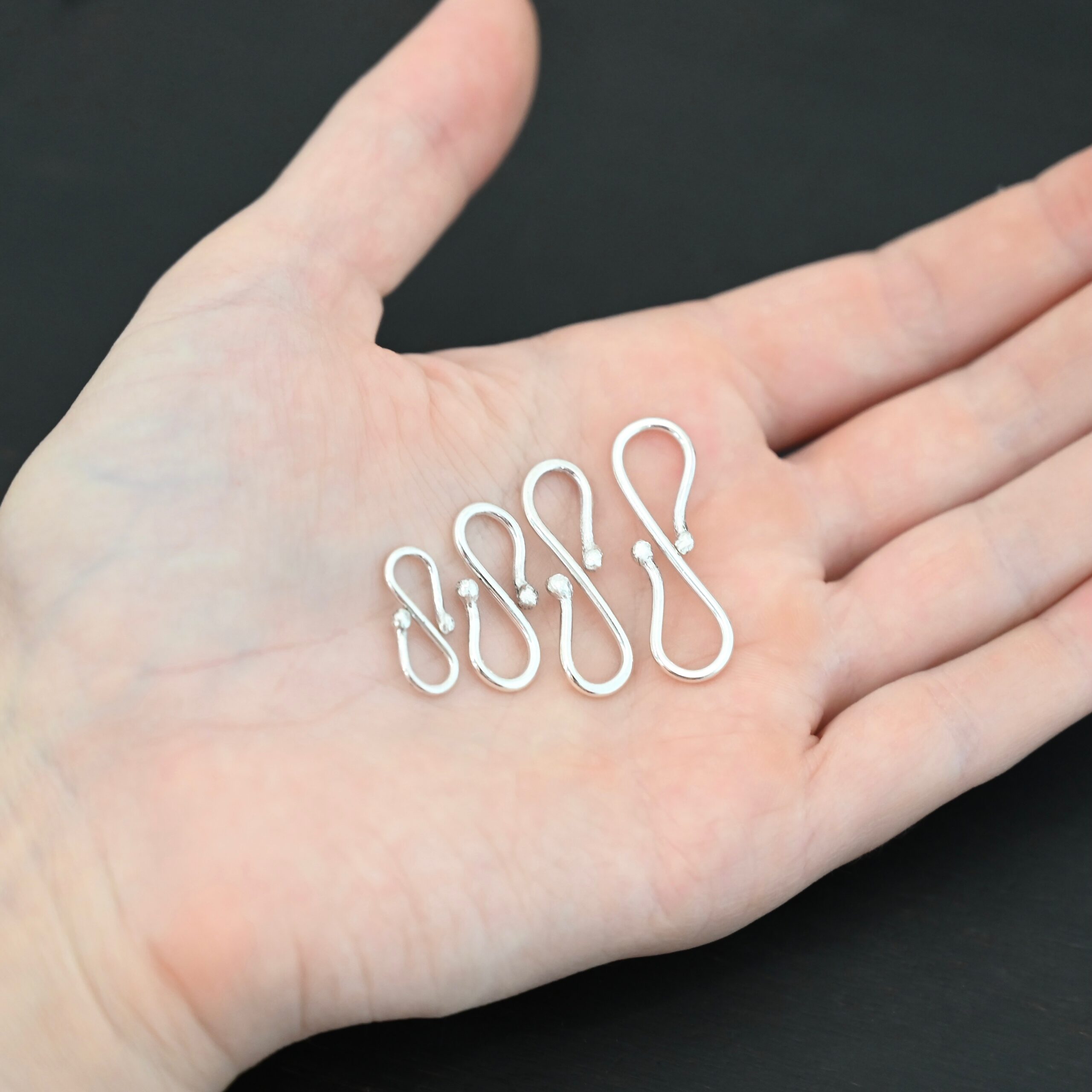 Saint S Clasp - shiny shown in hand