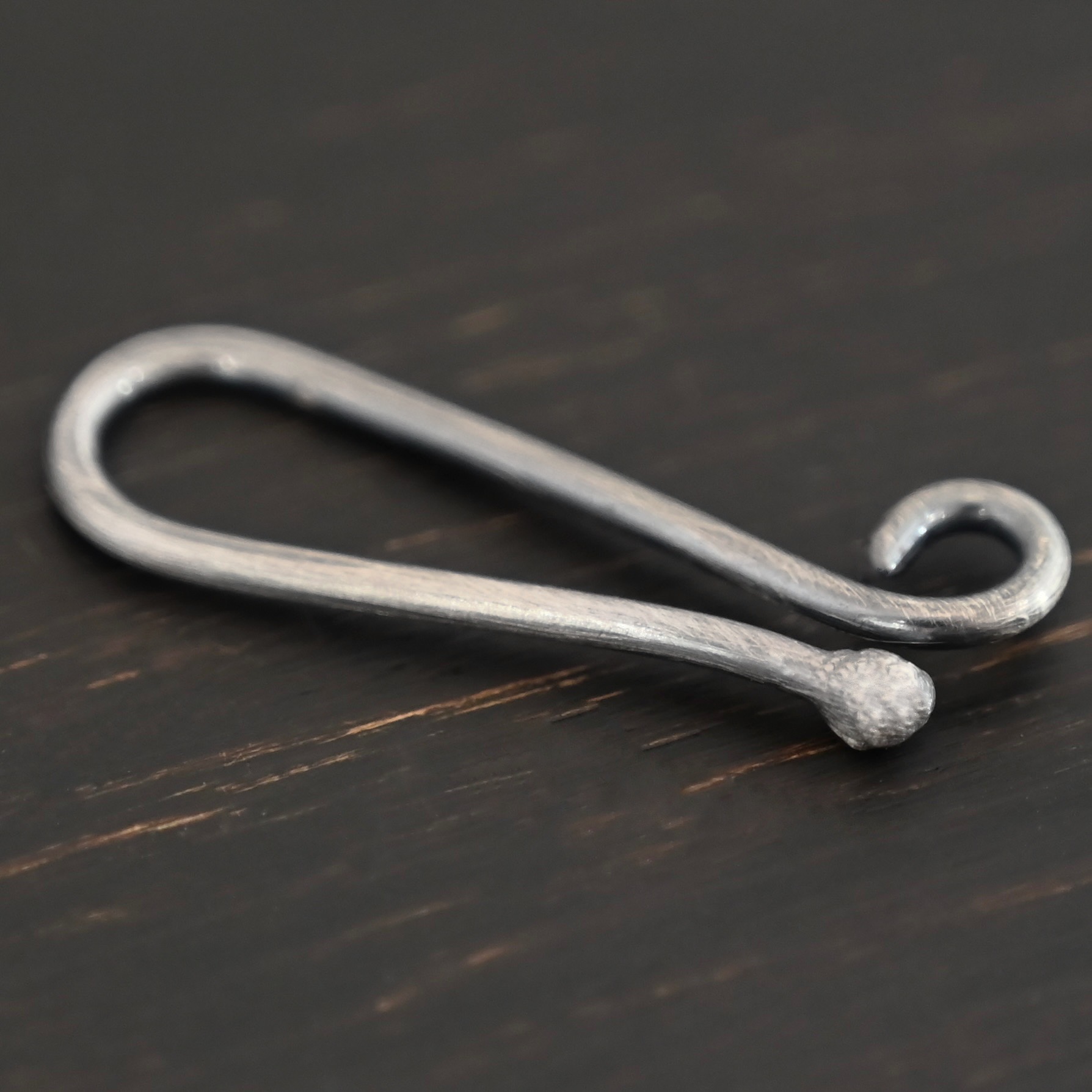Hazel Hook Clasp - oxidized shown on dark background