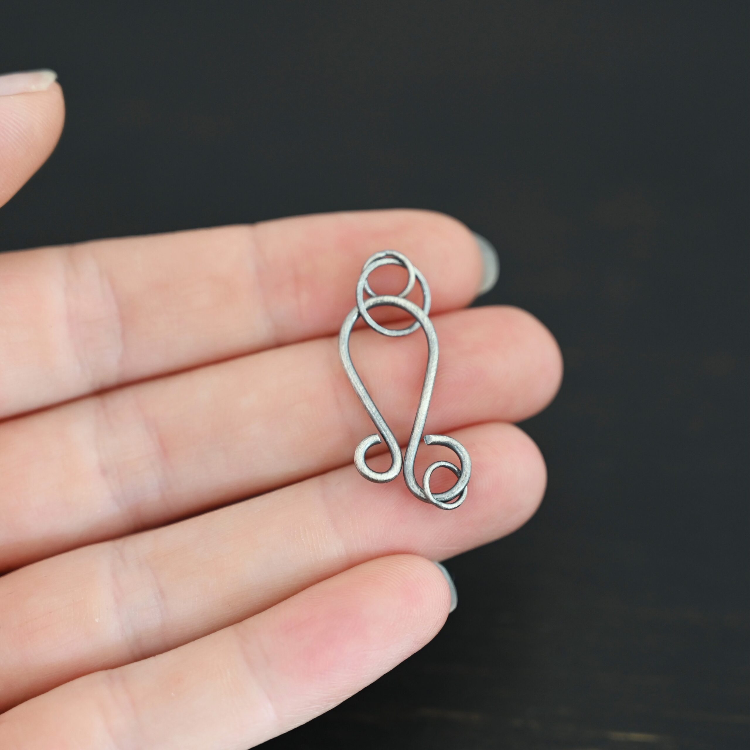 Harmony Hook Clasp - oxidized shown in hand