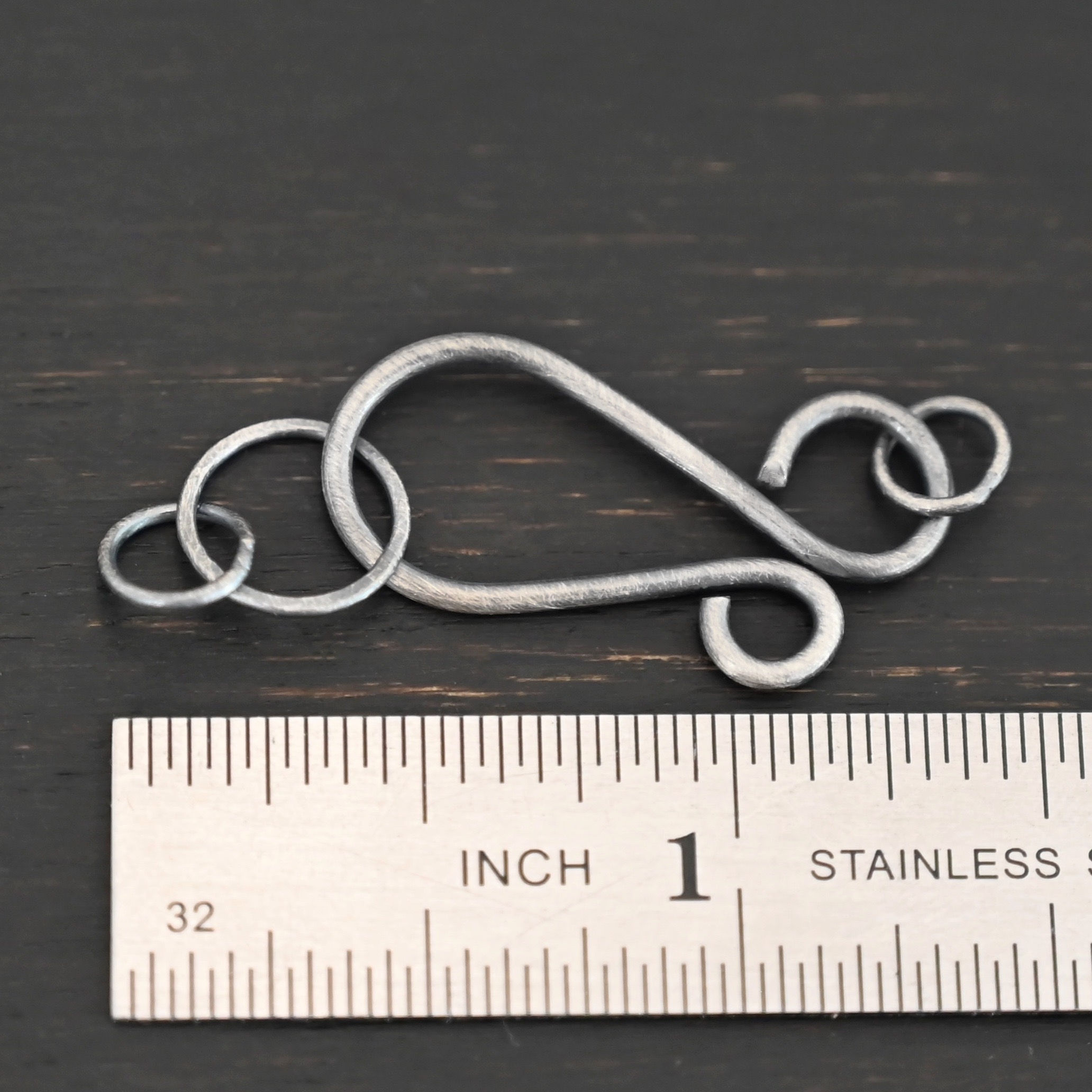 Harmony Hook Clasp - oxidized shown by ruler