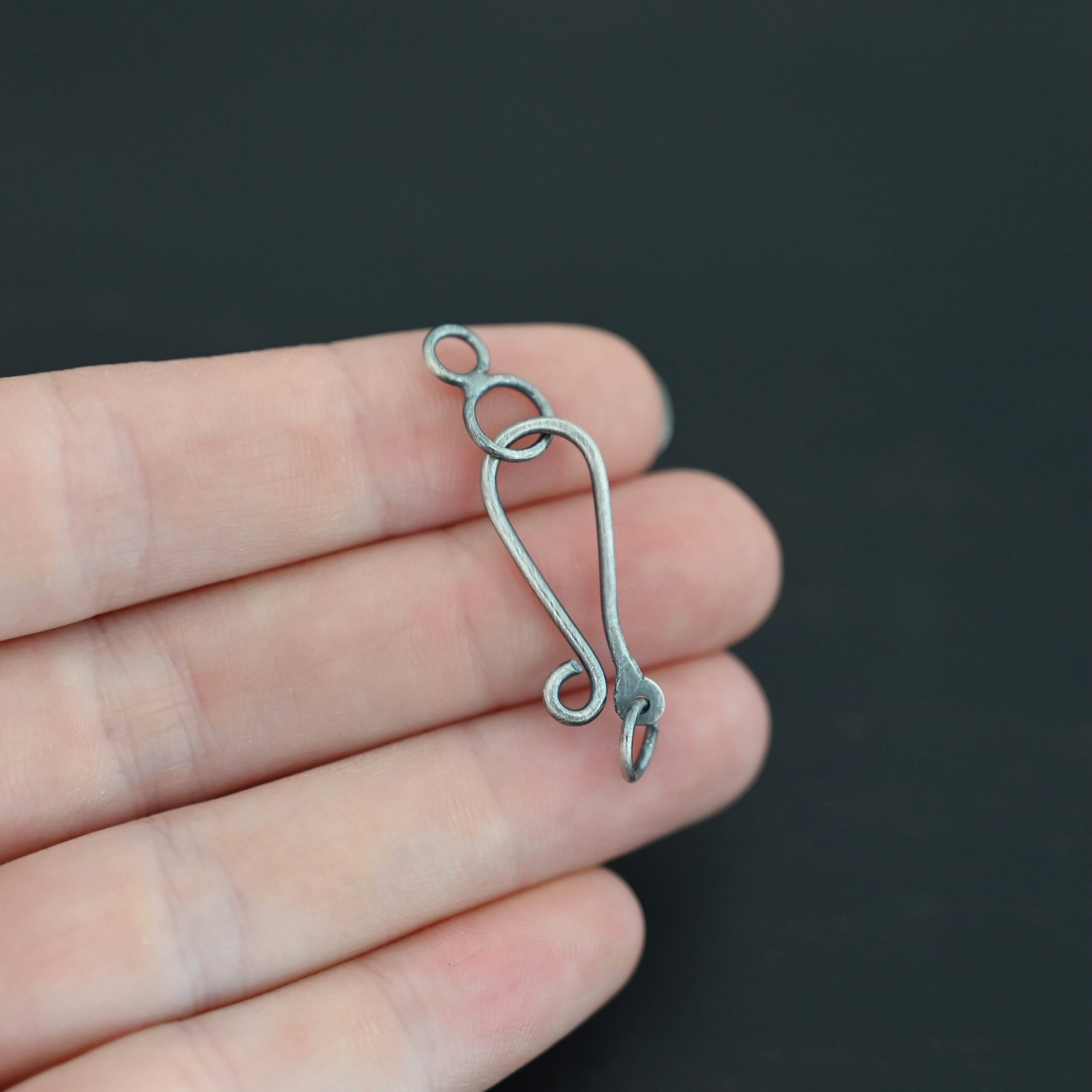 Haylee Hook Clasp - oxidized shown in hand