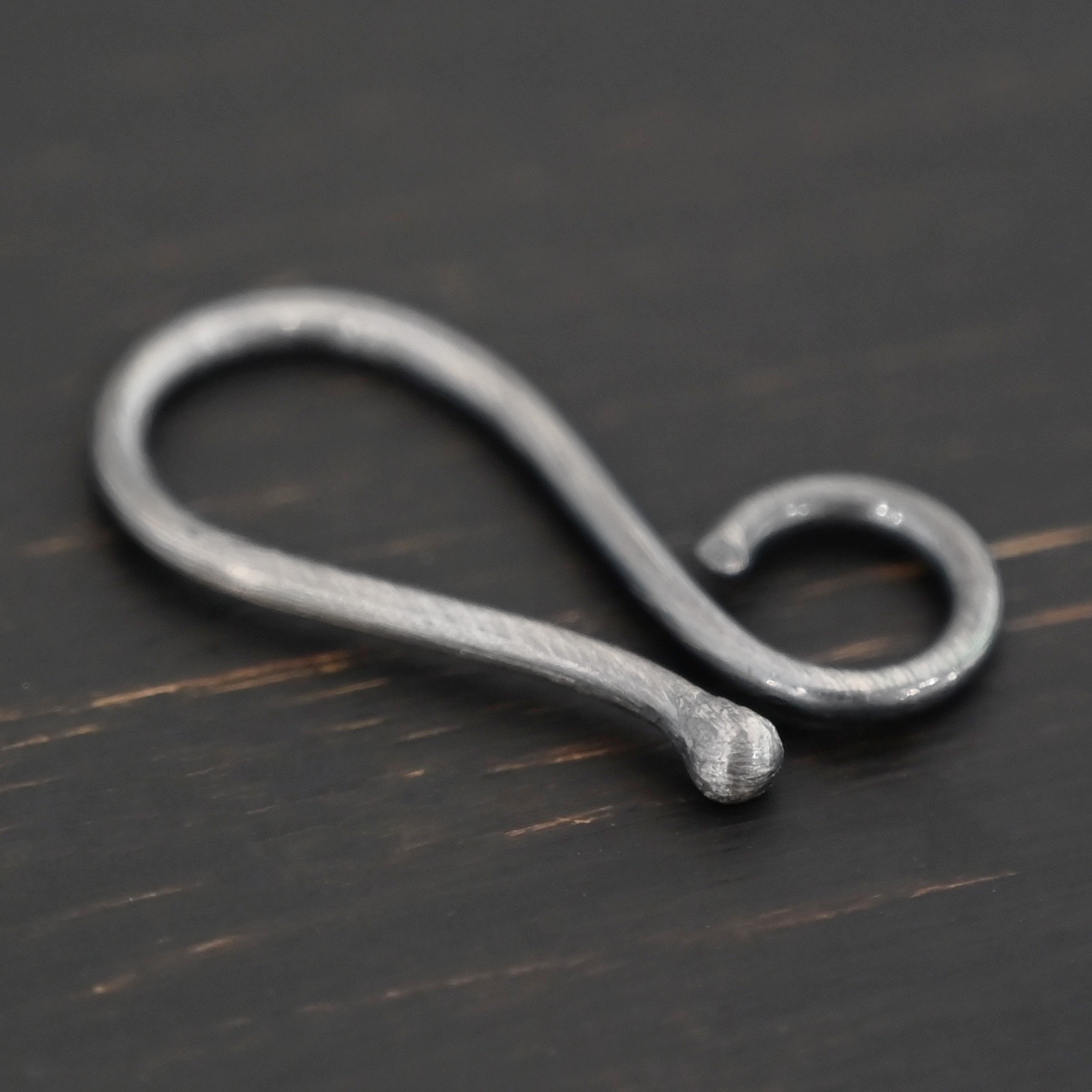Hendrix Hook Clasp - oxidized shown on dark background