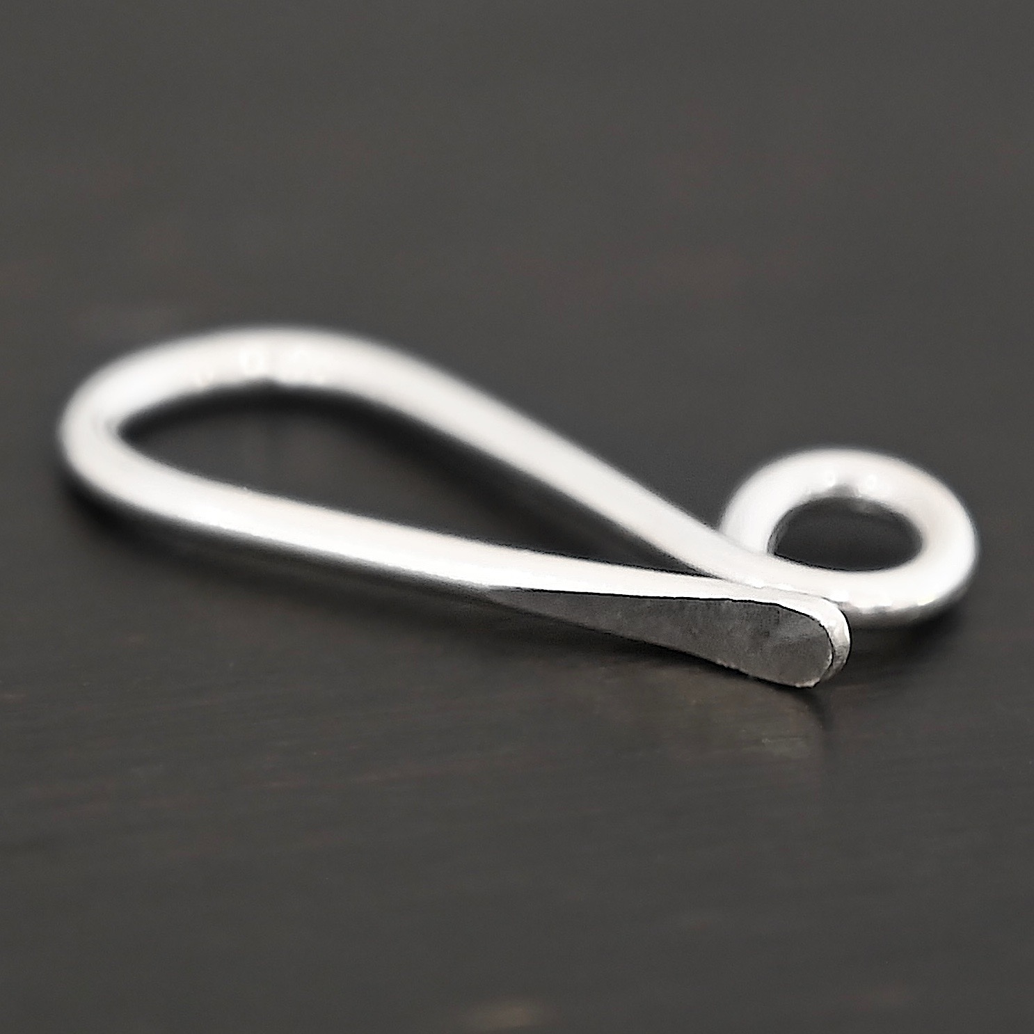 Hattie Hook Clasp - shiny Hattie Hook Clasp - shiny shown on dark background