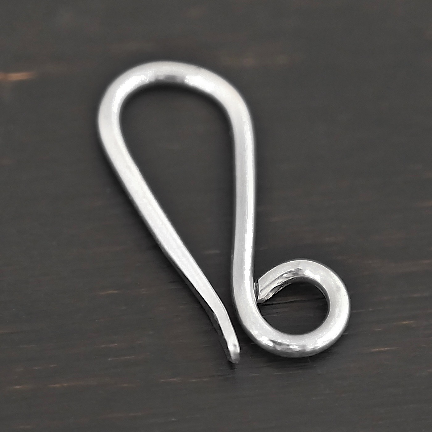 Hattie Hook Clasp - shiny Hattie Hook Clasp - shiny shown on dark background