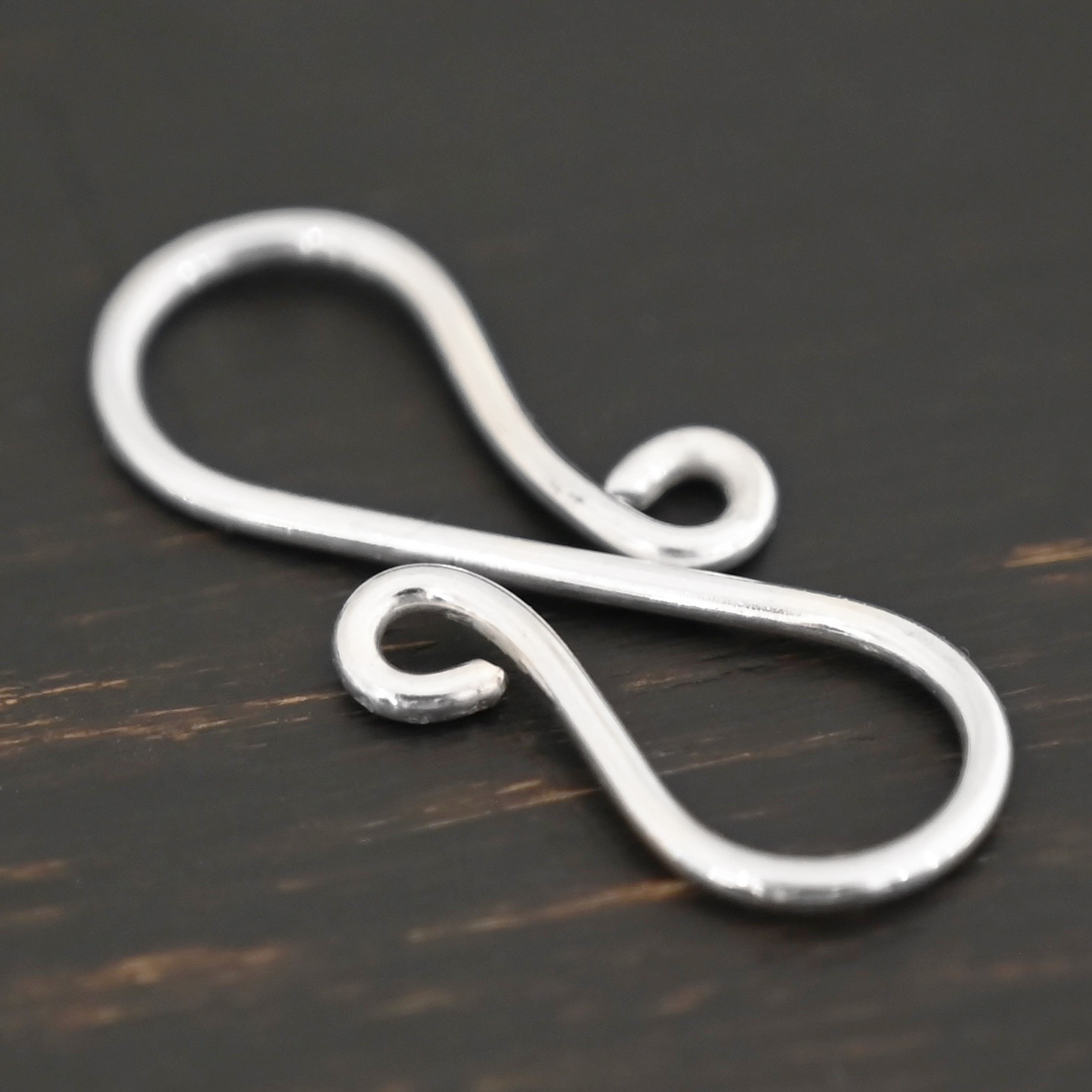 Summer S Clasp - shiny smooth shown on dark background