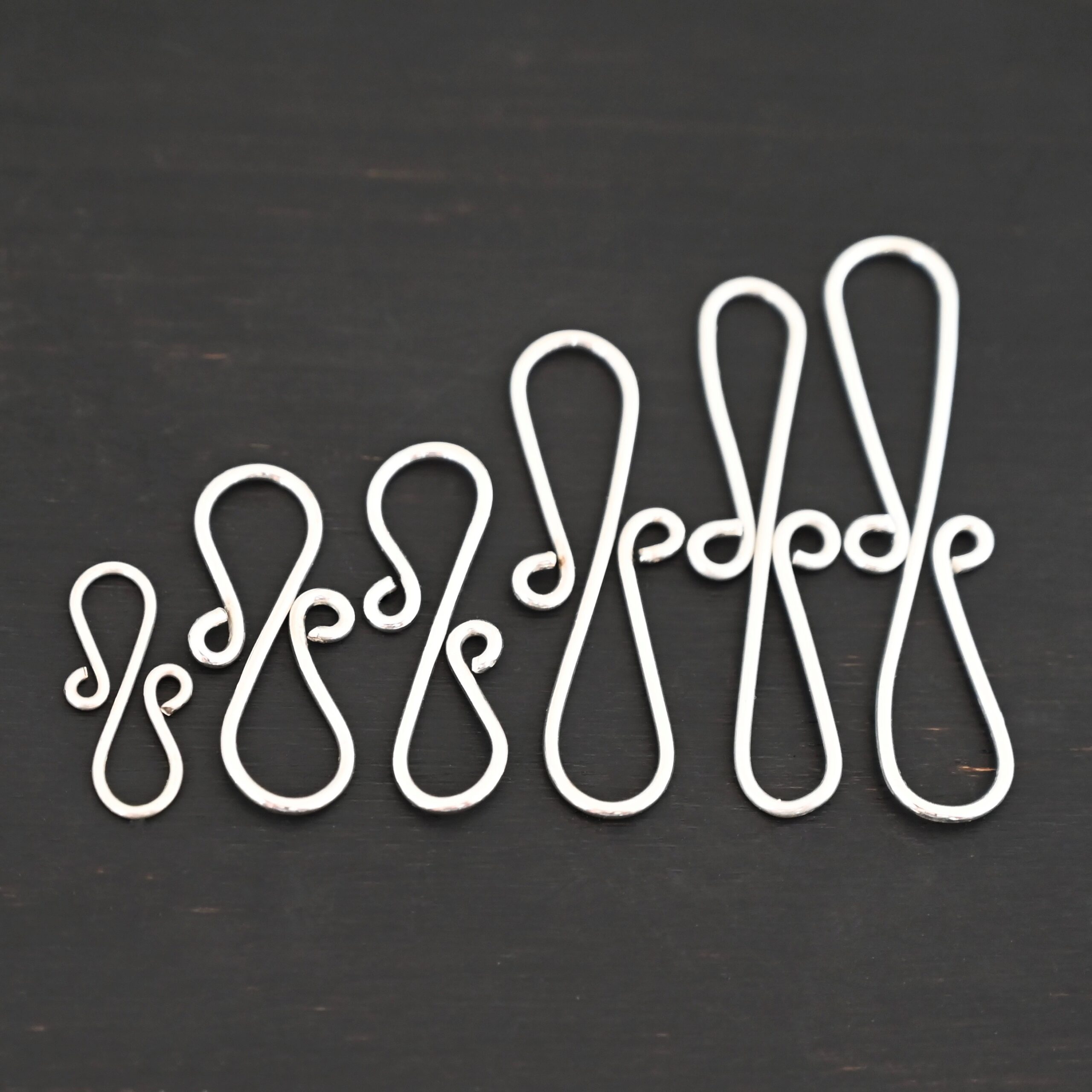 Summer S Clasp - shiny smooth shown on dark background