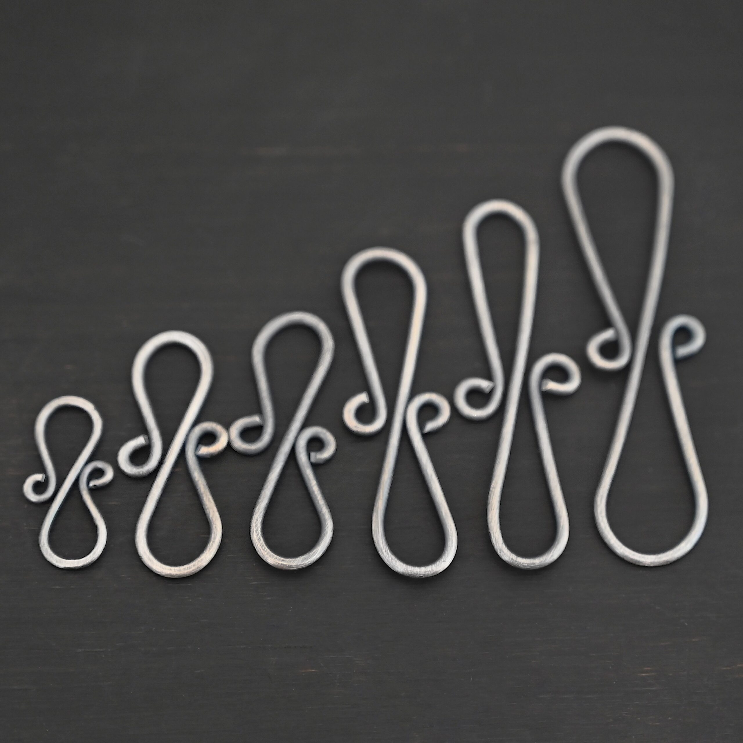 Summer S Clasp -oxidized smooth shown on dark background