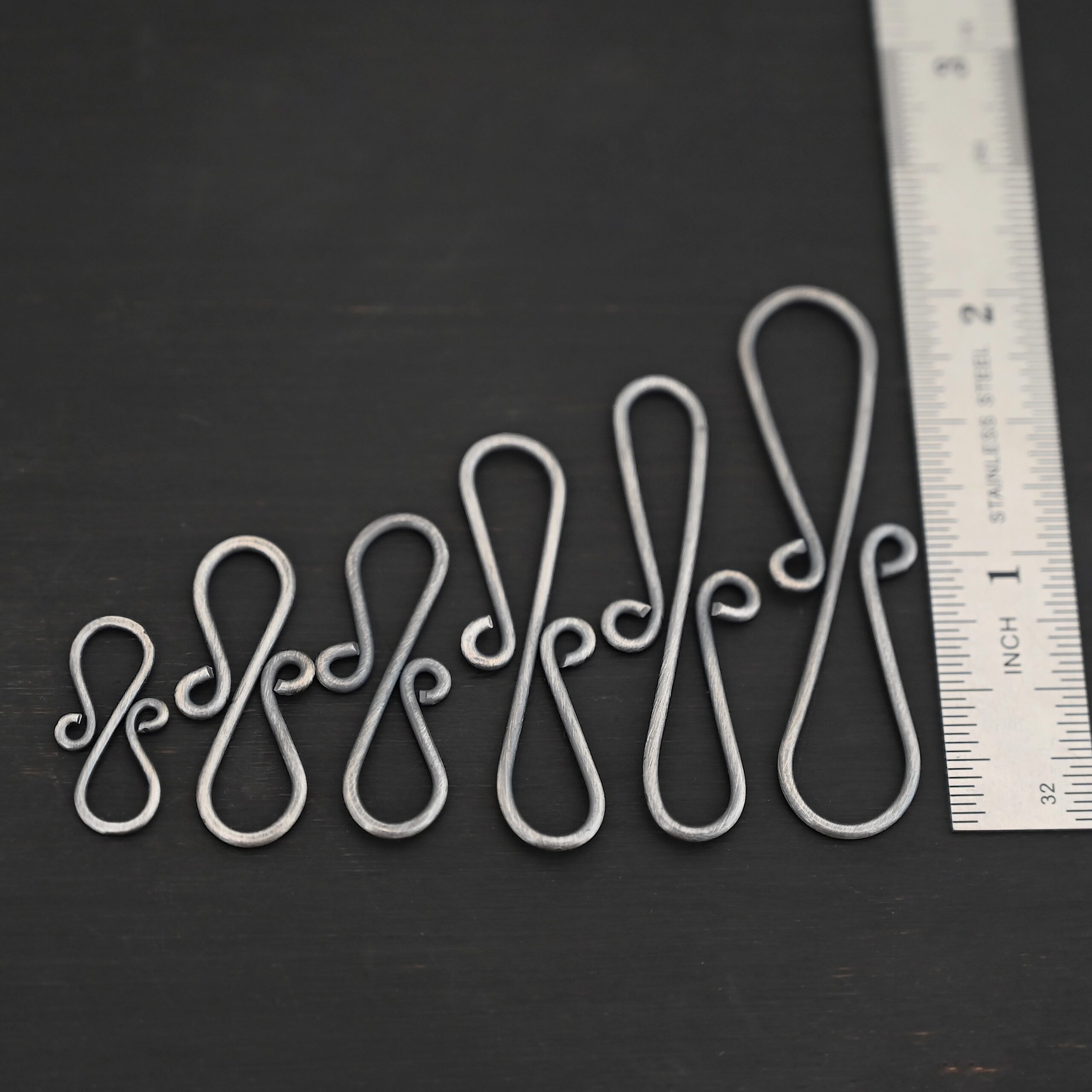 Summer S Clasp -oxidized smooth shown by ruler