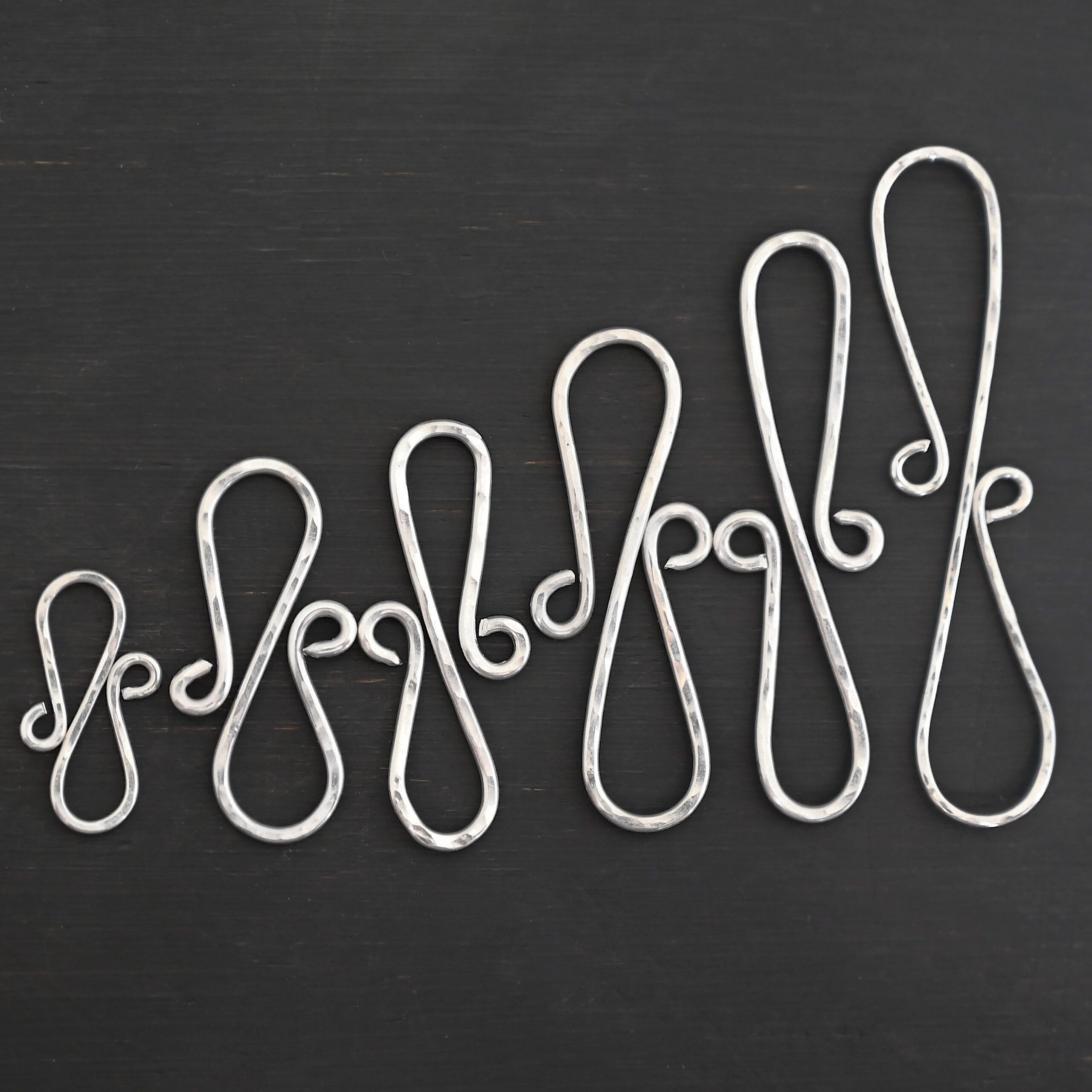 Summer S Clasp - shiny hammered shown on dark background