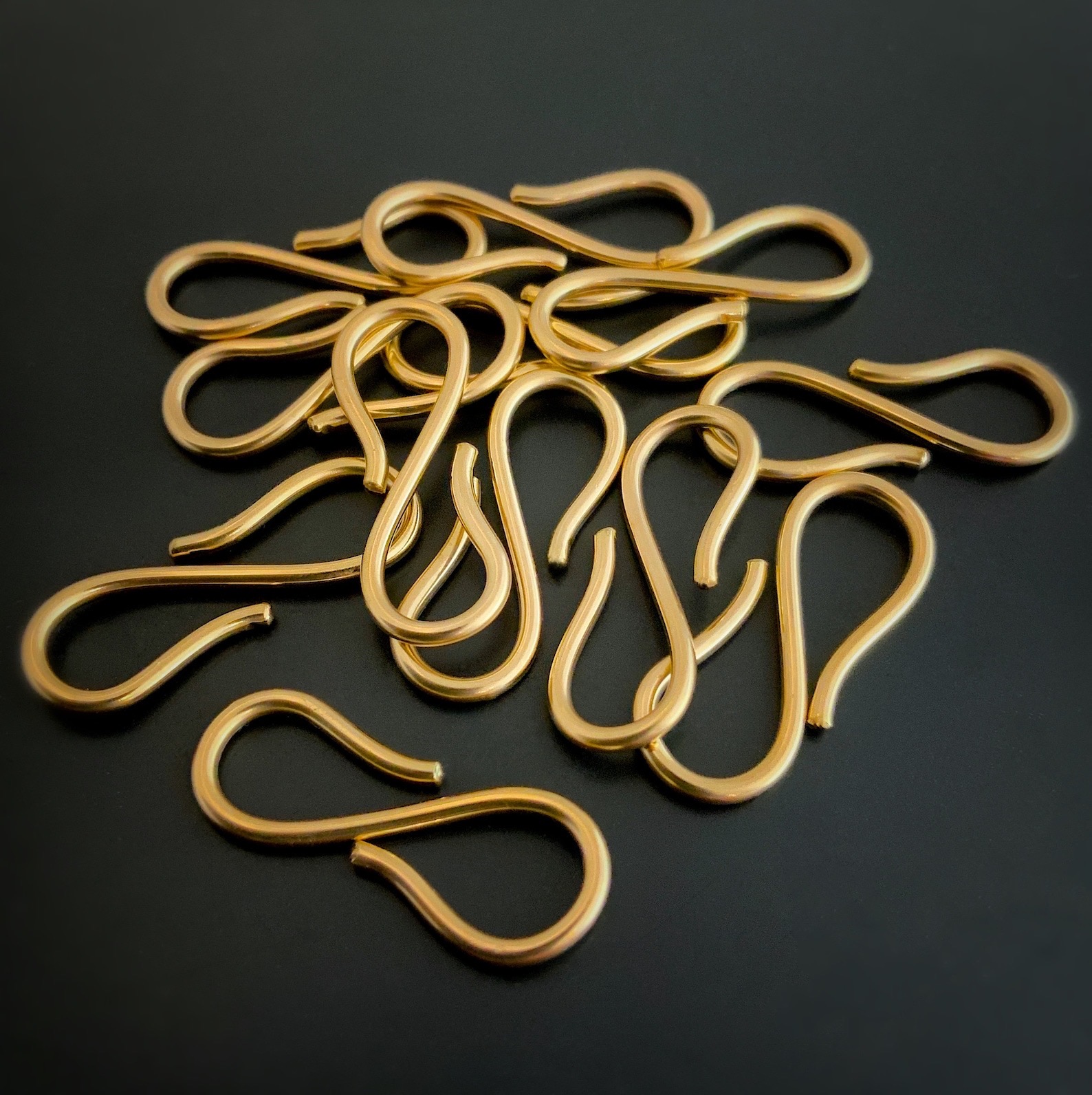 Stella 14k gold filled s claps shown on dark background