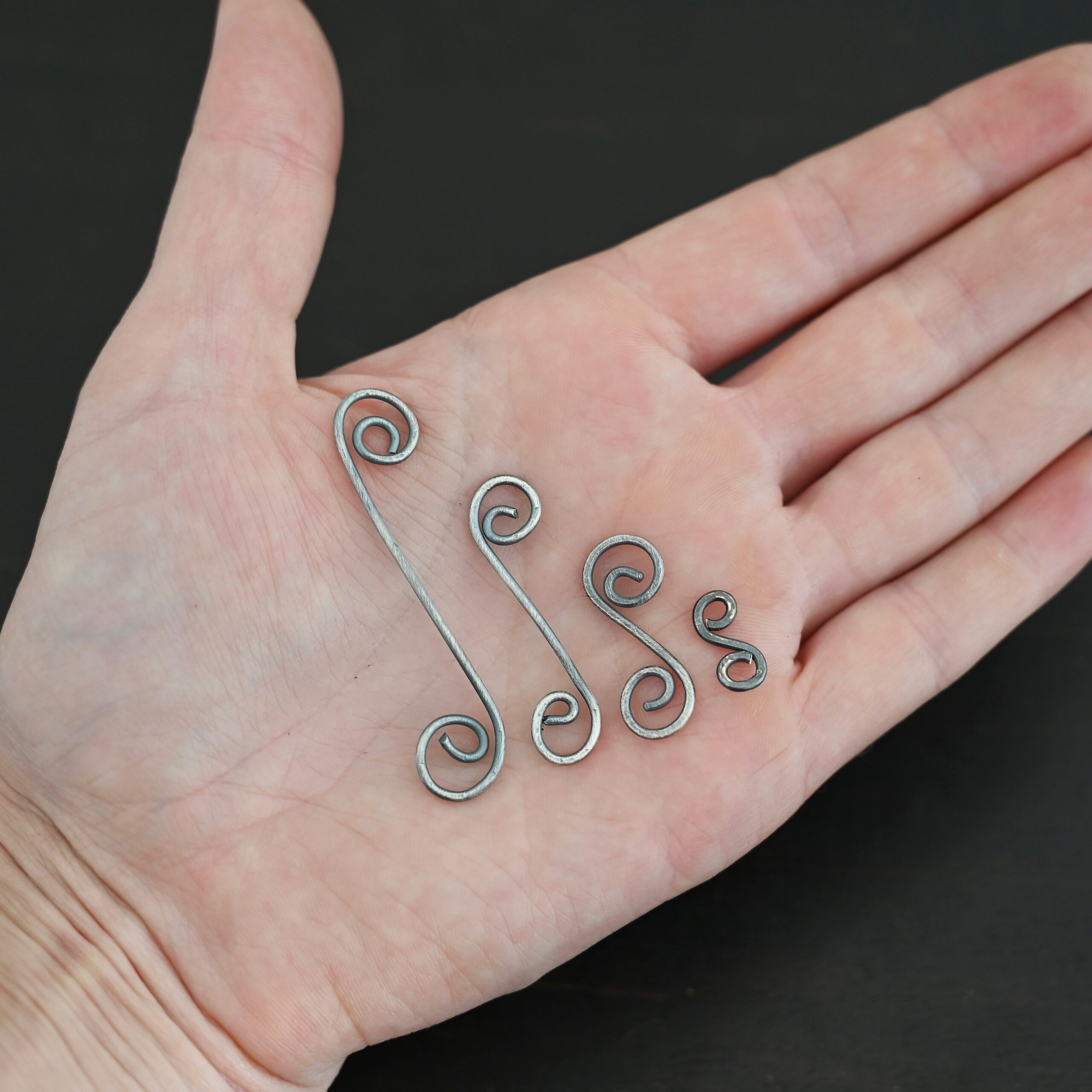 Hammered Swirl Finding - oxidized Hammered Swirl Finding - oxidized shown in hand