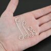 Hammered Swirl Finding - shiny shown in hand