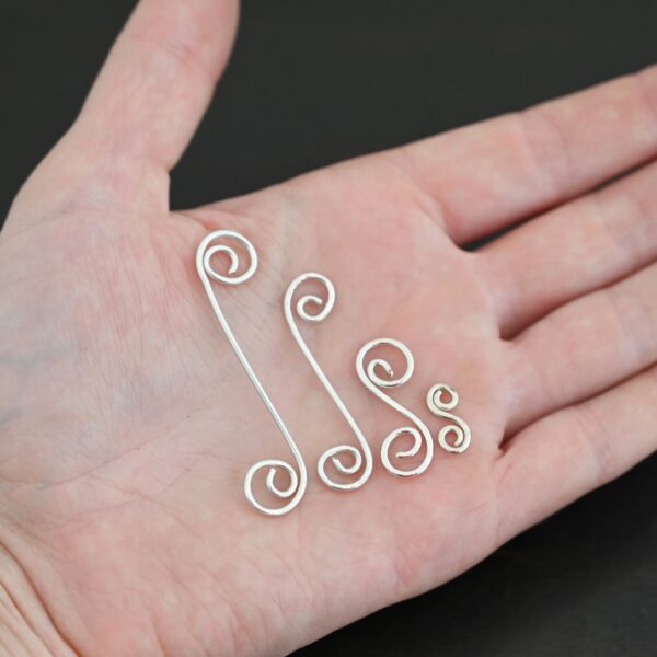 Hammered Swirl Finding - shiny shown in hand