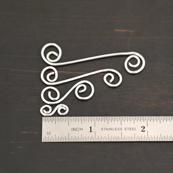 Hammered Swirl Finding - shiny shown by ruler