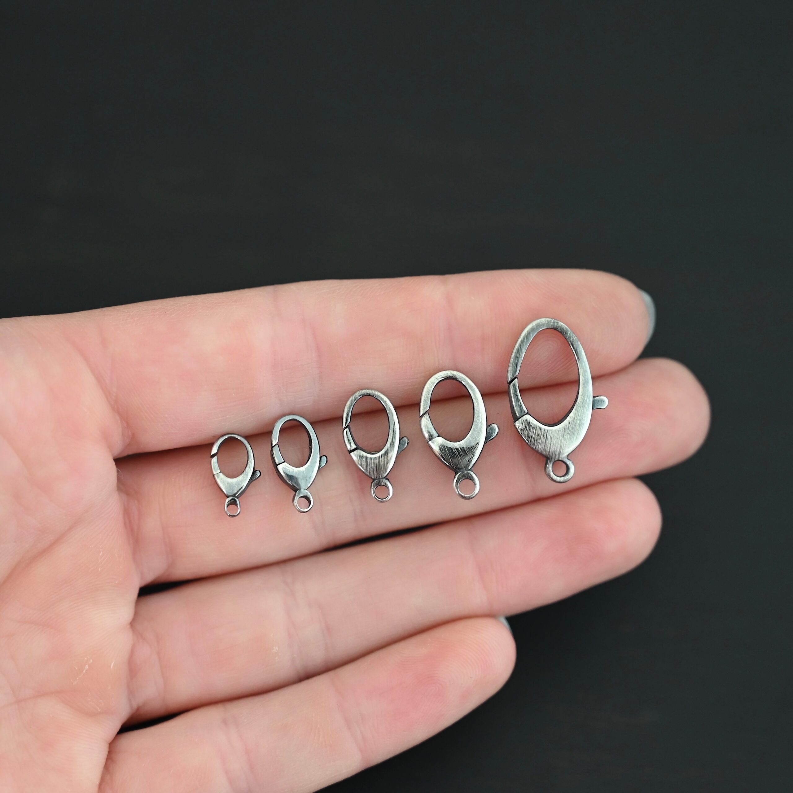 Luna Lobster Claw Clasp - oxidized shown in hand