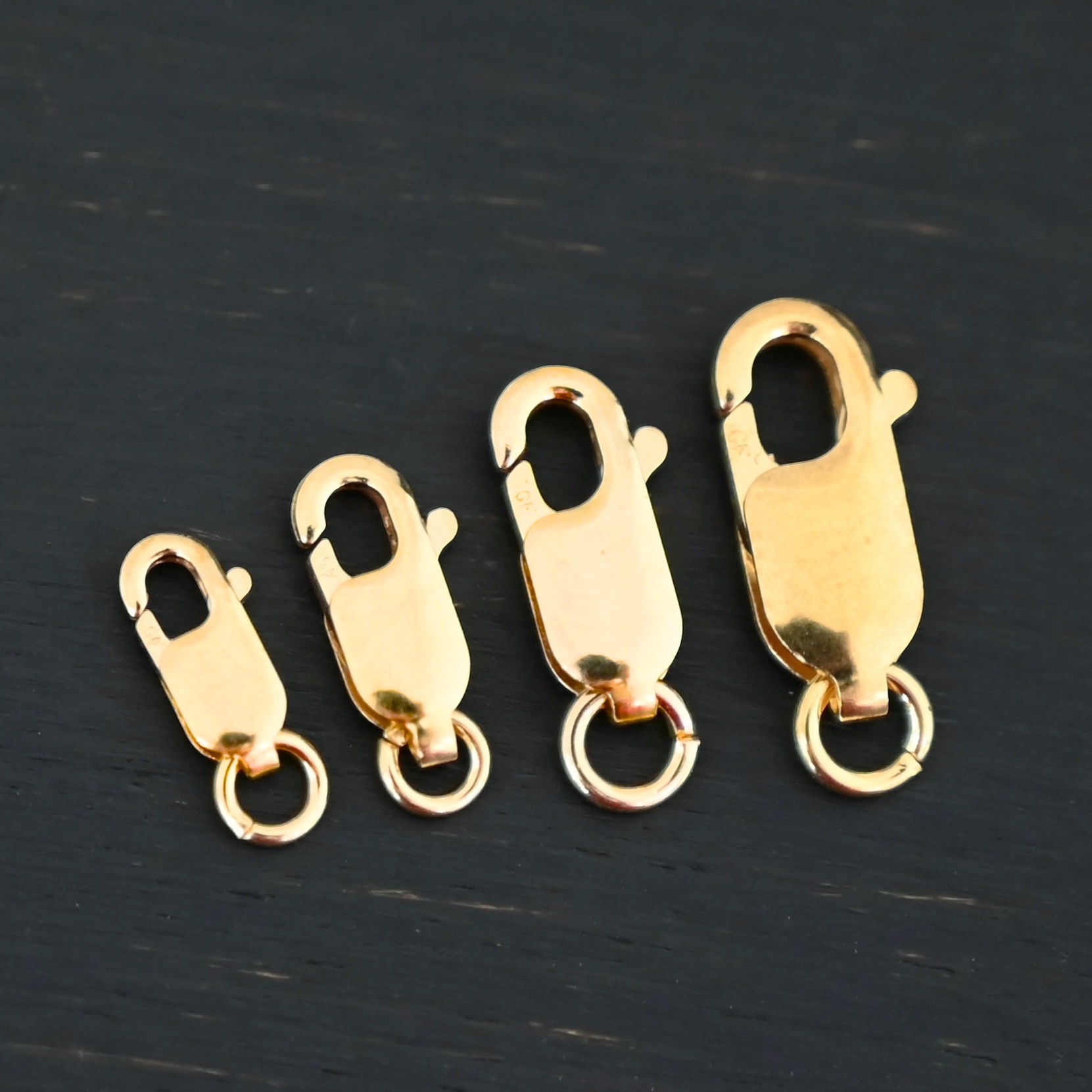 Lacey 14k gold filled Lobster Claw Clasp shown on dark background