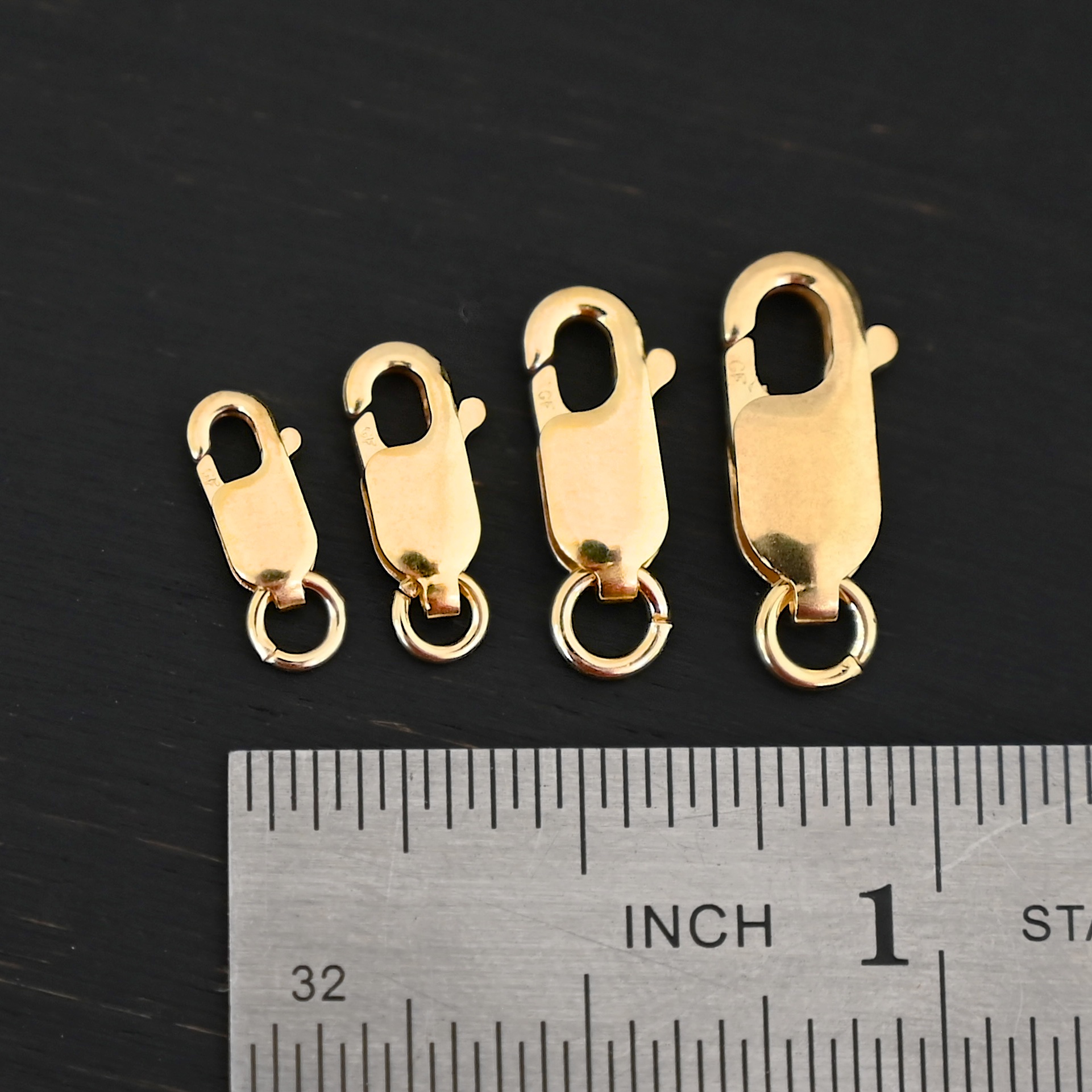 Lacey 14k gold filled Lobster Claw Clasp shown by ruler