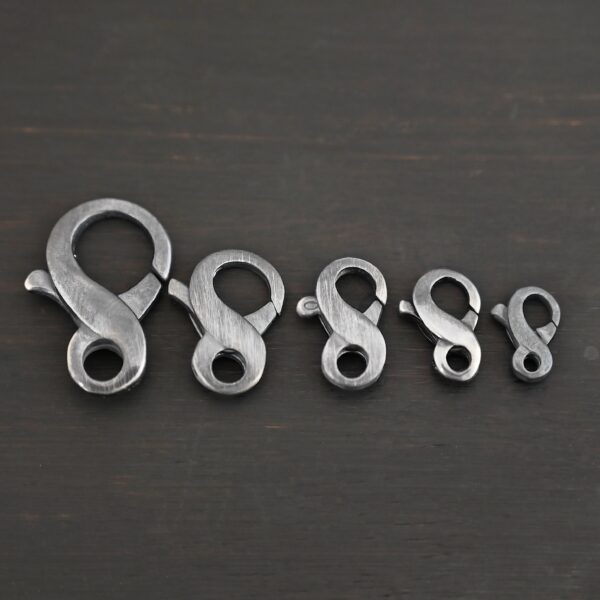 Faith Figure Eight Clasp - oxidized shown on dark background