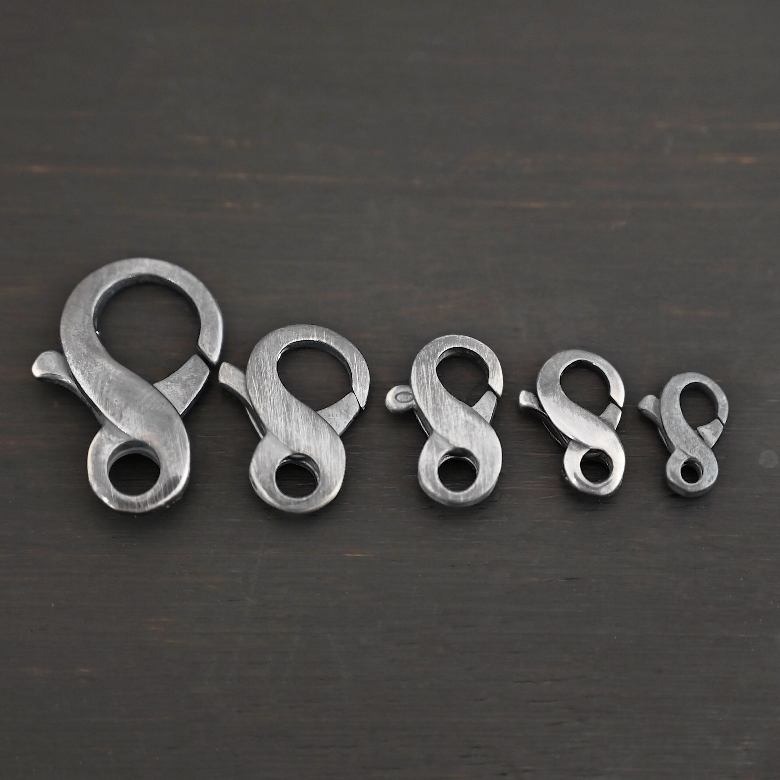 Faith Figure Eight Clasp - oxidized Faith Figure Eight Clasp - oxidized shown on dark background