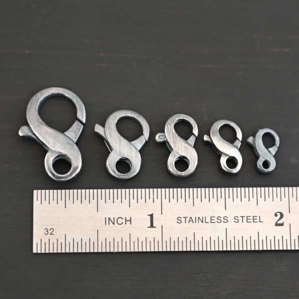 Faith Figure Eight Clasp - oxidized shown by ruler
