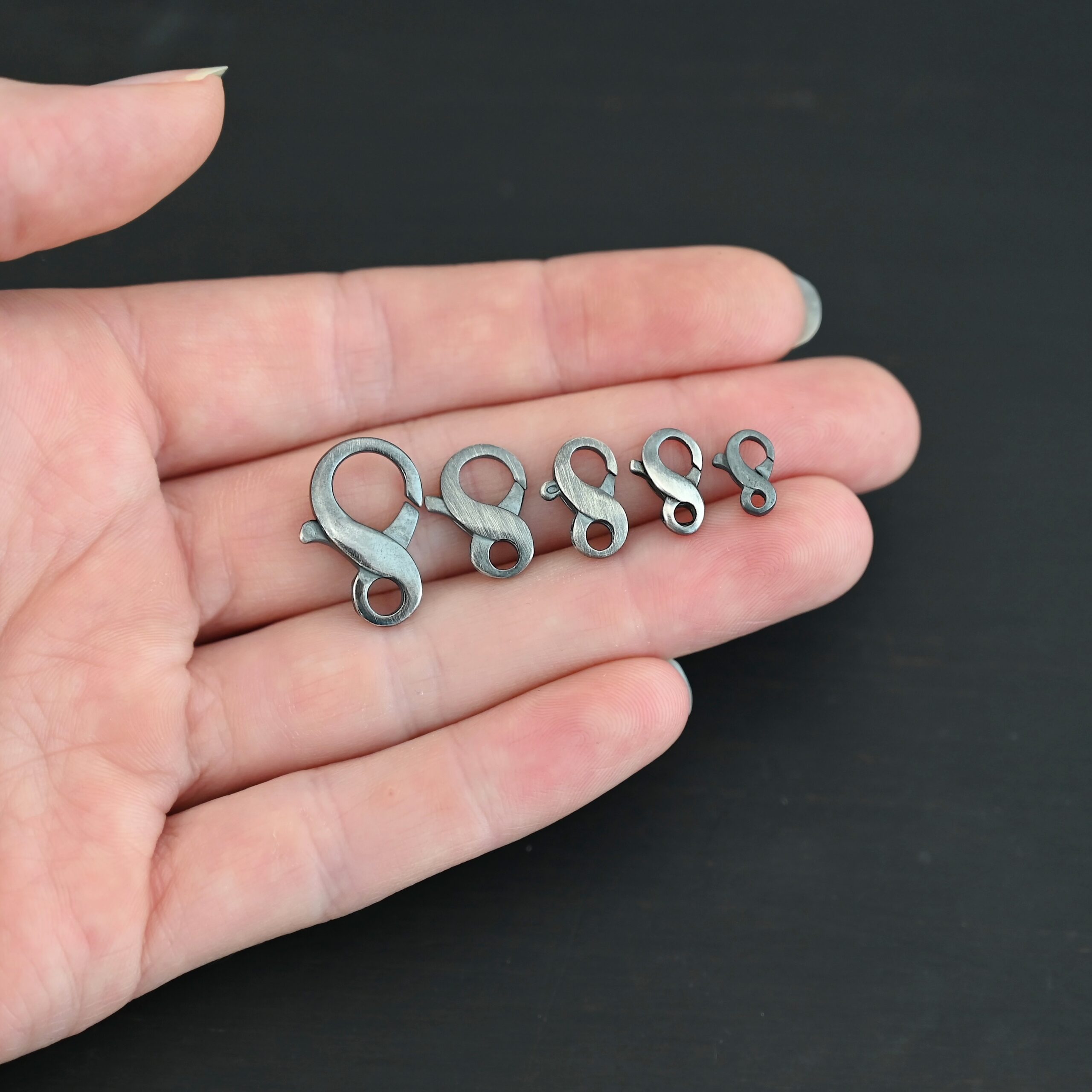 Faith Figure Eight Clasp - oxidized Faith Figure Eight Clasp - oxidized shown in hand