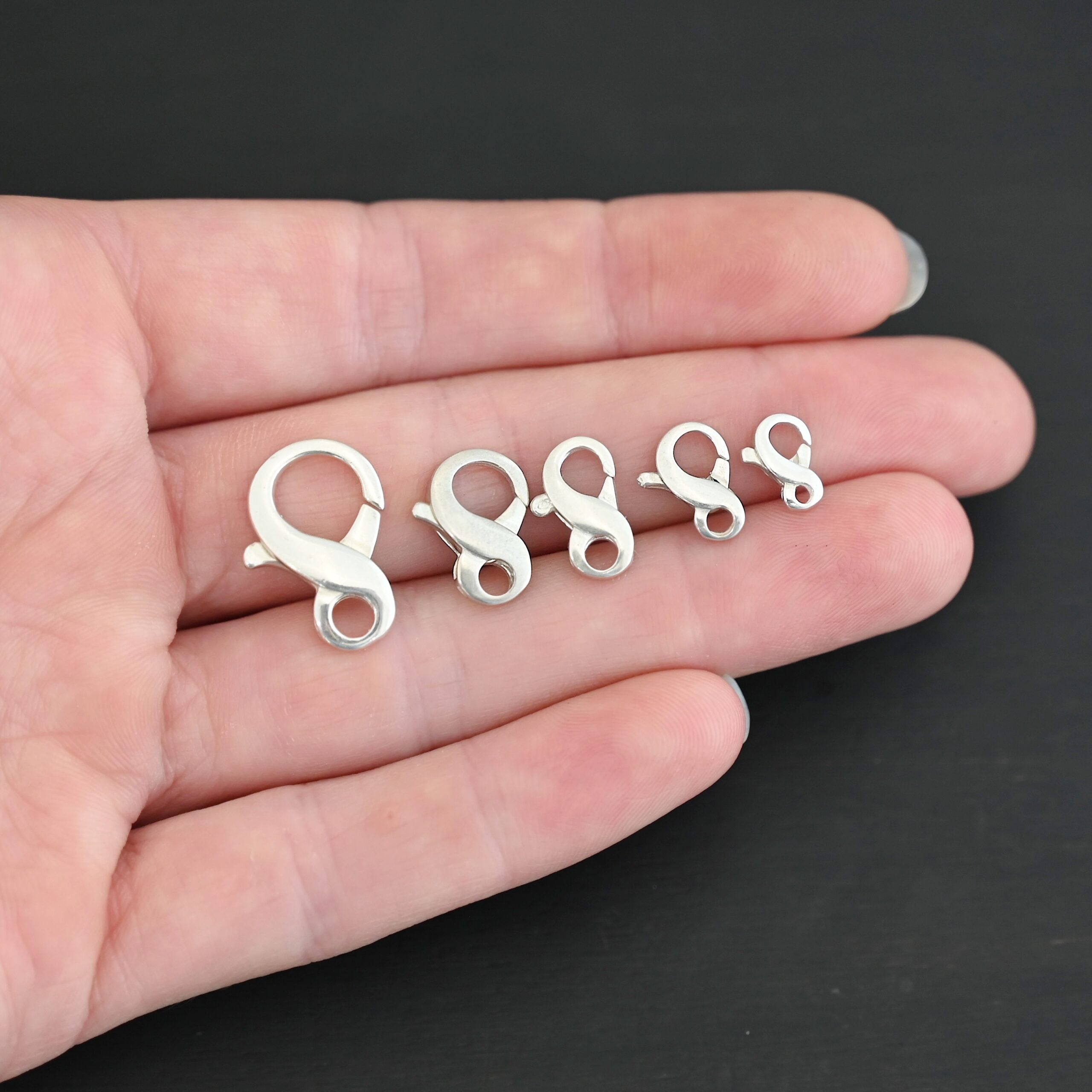 DSC_8408 Faith Figure Eight Clasp - shiny shown in hand