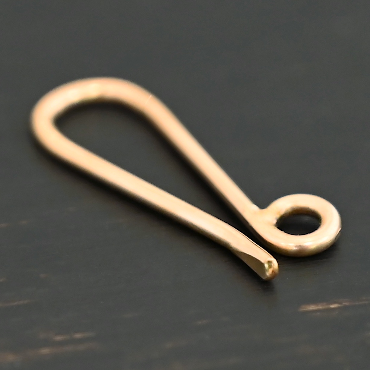 LIly 14k gold filled lobster claw clasp shown on dark background