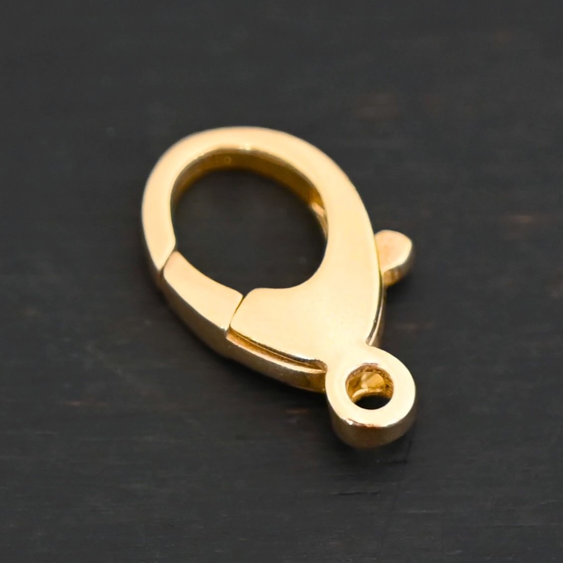 Lily 14k gold filled lobster claw clasp shown on dark background